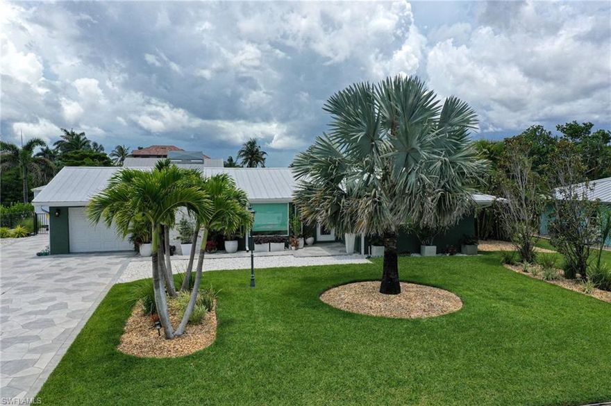 This wonderful 3 bedroom/2 bathroom pool home is a boaters paradise.  With a large composite dock, a wide canal, a 22,000lb boat lift complete with newer lift motors that are serviced regularly, and an intersecting canal you are ready for any boating adventure.  The interior of the home is perfect for entertaining or relaxing after a busy day.  Upgrades are noted all around and a good starting point is the wood burning fireplace, Carrara marble tile bathrooms, Taj Mahal granite for the kitchen and bathroom countertops, high end appliances, closet built-ins, and many more.  The outside is complete with an outdoor kitchen covered tiki style, and additional storage shed.  Everything inside the home and outside is regularly serviced and maintained.  Please set up a showing...this home is ready for you!