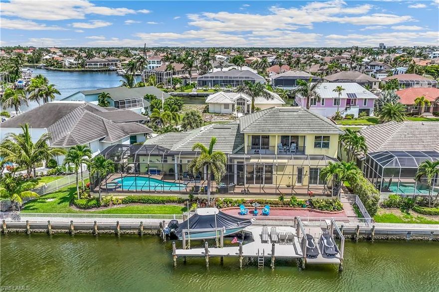 140 ft water frontage lot. This home exudes exceptional craftsmanship by Divco Custom Homes; one of the premier custom home builders in the Nation.  Upon entry of this sensational 2-story home with and open floor plan you see water views from nearly every window in this 4 bedroom plus den, 3 full baths over 3200 sq. ft. home.  North East rear exposure on a peaceful Cul-De-Sac, includes a 12K boat lift and custom 2 PWC lift with electric & lighting.  Large heated salt water pool and spa.  Hurricane sliders and windows. Main level Air Conditioning August 2023, Garage and 2nd floor Air Conditioning 2020. Kitchen applicances 2017. Hot Water heaters 2019 & 2020. Generac 20 kw propane (500 gallon tank) GENERATOR. Security & Intercom system, Tile roof 2018.