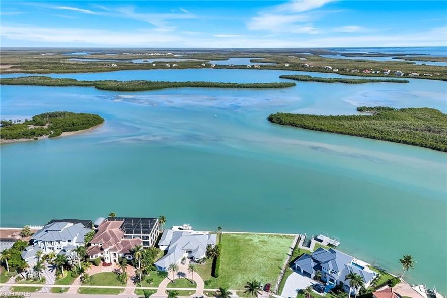 A Truly Rare Opportunity!
Claim your slice of paradise with this large .54-acre waterfront lot featuring an impressive 166 feet of direct water frontage in the prestigious Estates section of Marco Island. With a brand-new seawall recently installed, this homesite is fully prepped and ready for you to build the luxury residence of your dreams.

What makes this property extraordinary is its unrivaled, panoramic view overlooking Caxambas Bay, where Barfield Bay and Caxambas Pass come together in a breathtaking display of open water, shimmering light, and untouched nature. Beyond the mangroves, the famed 10,000 Islands stretch toward the horizon, offering a sense of tranquility and seclusion that feels worlds away—yet you're still right at home on Marco Island.

Boaters will love the quick, direct access to the Gulf, placing incredible fishing, wildlife sightings, and endless exploration literally in your backyard. Whether you envision a serene coastal retreat or a spectacular estate home, this location offers one of the most captivating settings on the island.

This exceptional 1/2 acre lot is a must-see—opportunities like this simply don't come around often.