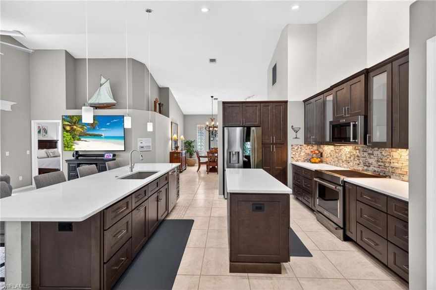 If you’re looking for a home where the updates are already done and the lifestyle is built in, this one is easy to love.
Walk into incredible VOLUME CEILINGS that make the whole home feel open and bright**UPDATED KITCHEN with QUARTZ COUNTERS, PREP STATION, HUGE CENTER ISLAND, STAINLESS STEEL APPLIANCES, INDUCTION RANGE**Built-in Dry Bar**TILE FLOORING throughout for a clean, low-maintenance feel**Flex room with a queen Murphy bed and built-in storage, perfect for guests or a home office**Guest Bedroom offers even more added storage. Custom window treatments already in place**Primary BATH UPDATE with a sleek curbless walk-in shower. This home is also dialed in when it comes to peace of mind:  Whole-house generator with 500-gallon propane tank**Hurricane shutters, manual and electric**A Couple Impact Windows**Hurricane-rated garage door**Air-conditioned garage with professional floor coating, great for storage, hobbies, or just keeping things cool. Step outside and it gets even better:  Resurfaced pool with solar heating**Outdoor shower**Paver driveway**Relaxing views of the golf course and lake, the kind of backdrop you don’t get tired of. All of this is set inside The Landings Yacht, Golf & Tennis Club, where the lifestyle is just as impressive as the home: UNLIMITED Golf, tennis, pickleball, and bocce, Full-Service Marina with boat slips (based on availability), Fitness center, Two on-site restaurants, Scenic walking trails throughout the community. And when you leave the gates, you’re minutes from the Fort Myers River District, live theaters, spring training games, and Southwest Florida’s beaches. Bottom line, this is a move-in ready home with real upgrades, great views, and a community people move here for.