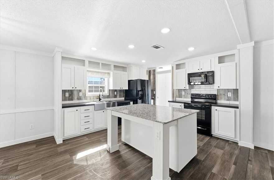 Discover the perfect blend of comfort and community in this never lived in 3-bedroom, 2-bathroom manufactured home nestled within the sought-after Old Bridge Village—a vibrant 55+ waterfront community along the Caloosahatchee River. This spacious 1,378 square foot true double-wide has brand new appliances, a new AC system, new electrical service and room for a carport. The open-concept floor plan welcomes you with stunning LVP flooring throughout and a striking accent wall featuring a cozy fireplace with mantle—perfect for relaxing evenings at home. The heart of this residence is the gorgeous kitchen, showcasing crisp white shaker cabinets and a generous island with ample storage space. Retreat to your primary suite complete with an ensuite bathroom boasting dual sinks and a spacious shower. With the home freshly elevated to meet new flood level requirements and a February 2026 Certificate of Occupancy in hand, you can move in with complete peace of mind. Beyond your doorstep awaits an active social community brimming with amenities: two heated pools, spa, fitness center, clubhouse, tennis, pickleball, bocce, and shuffleboard courts. Boating enthusiasts will delight in the deep-water marina featuring 81 slips with direct Gulf access. Enjoy nearby Powell Creek Preserve for nature walks, convenient access to the NFM Library, and proximity to Fort Myers Downtown Commercial District for shopping and dining adventures. Added Bonus - Opportunity to purchase the lot and a simplified closing via title transfer. Your Florida paradise awaits!