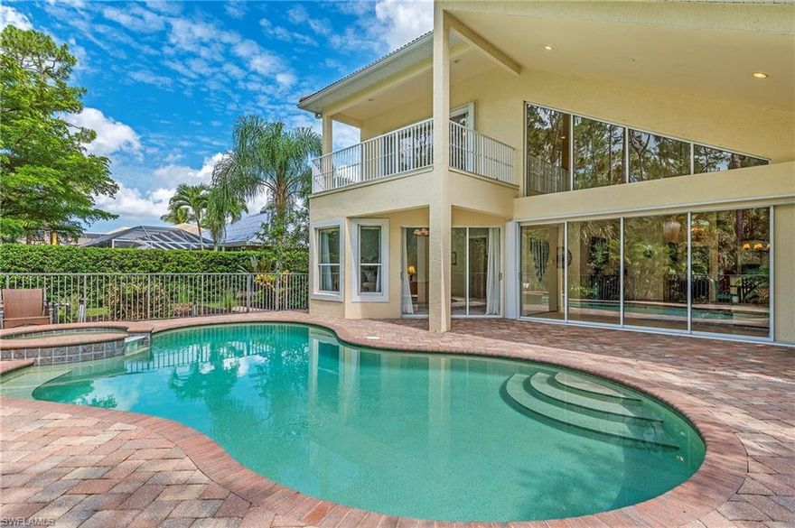 Situated on a gorgeous lot overlooking the preserve, this stunning 2-story residence is nestled within the much sought after gated community of Wilshire Lakes. Beautiful wooded views envelope this stunning home with privacy & tranquil setting. With over 3,000 sq. ft. of living area, this 4 BD+loft, 3 BA pool home boasts soaring ceilings, bamboo floors, and plenty of modern nuances including stainless steel kitchen appliances, granite, beautiful cabinetry, newer A/C and designer fixtures. The spacious main level Master Suite is luxurious with a bay window, sliders that open to the pool, his and hers walk-in closets, dual granite vanities, large soaking bathtub, and a huge shower. Main level guest en suite and dining area which could easily be an office. Loft space features a large adjoining balcony with the perfect picturesque setting for nature viewing. Enjoy the abundance of outdoor living space complete with both covered and open lanai area, pool and spa. Community amenities include manned gated entry, convenient central location, quick access to Mercato, Waterside Shoppes, and Naples’ sugar sand beaches + neighborhood amenities including clubhouse, 2 pools/spa/tennis& fitness.