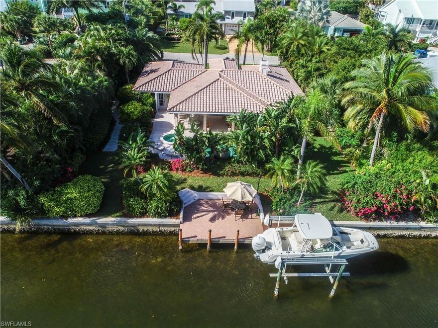 Relaxation and appreciation for outdoor waterfront living and privacy are what you will feel with this beautiful canal front home located on Sanibel's convenient east end of the island. Awesome remodeled getaway home with quick boating access out to the gulf and bay waters along with deeded beach access just steps away. The home features 2/3 bedrooms and 3 full baths with lots of upgrades such as brick paver drive, barrel tile roof, gorgeous tiled floors and a great room with a beautiful fireplace. Open kitchen with upscale cabinetry, granite counters, dining room w/framed in beautiful edgeless glass designed as a bay window offering views of the stunning pool/spa area, private fenced in back yard and the intersecting canal are all here to enjoy. Experience a large covered roll down screen lanai area w/grilling station, outdoor bar, beautiful tropical vegetation, large dock and boat lift area on a seawalled canal. This is a great waterfront home and value for the islands.