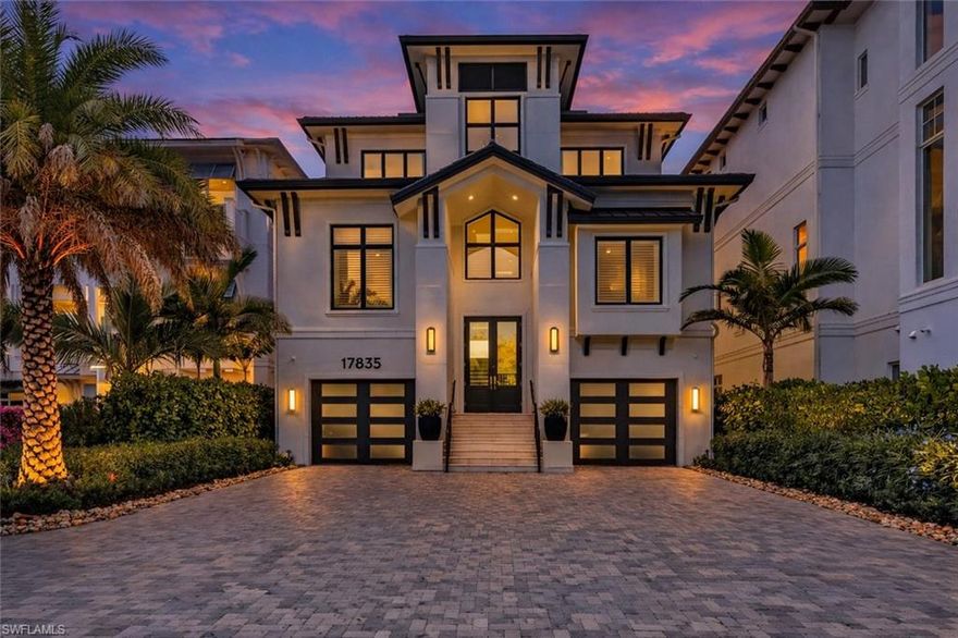 Experience the pinnacle of modern luxury on this extraordinary beachfront, award winning lakefront estate within the exclusive Sardinia enclave at Miromar Lakes Beach & Golf Club. Boasting coveted southern exposure and 4,966 square feet of impeccably designed living space, this 4-bedroom residence with two private dens, 4 full baths, and 2 half baths offers refined contemporary elegance with breathtaking water views from nearly every room.

Curated by Theory Design, the interiors are a masterclass in sophistication, featuring soaring ceilings, bespoke designer finishes, and seamless indoor-outdoor flow. The open-concept great room is anchored by a gourmet chef’s kitchen outfitted with top-tier appliances, sleek custom cabinetry, and an expansive island—perfect for both everyday living and elevated entertaining. The home’s primary living area is thoughtfully positioned on the upper level, creating a serene private retreat complete with tranquil lake views and a spa-inspired primary bath. Two beautifully appointed dens provide flexible space for a home office, media lounge, or additional guest accommodations.

The outdoor living experience is nothing short of spectacular. Enjoy a private white-sand beach and boat dock, along with a first-floor custom infinity-edge pool and spa enhanced by a dramatic water wall and fire bowl feature. Multiple lounging and dining areas overlook shimmering lake views, creating a striking yet tranquil backdrop for entertaining or unwinding in complete privacy.

Additional highlights include a 4-car garage, thoughtful architectural details throughout, and effortless access to Miromar Lakes’ world-renowned amenities. Residents of Sardinia enjoy 700 acres of freshwater lakes, three miles of private beaches, championship golf, tennis and pickleball courts, a full-service spa and fitness center, exceptional dining, and a vibrant social lifestyle—set within one of Southwest Florida’s most coveted luxury communities.