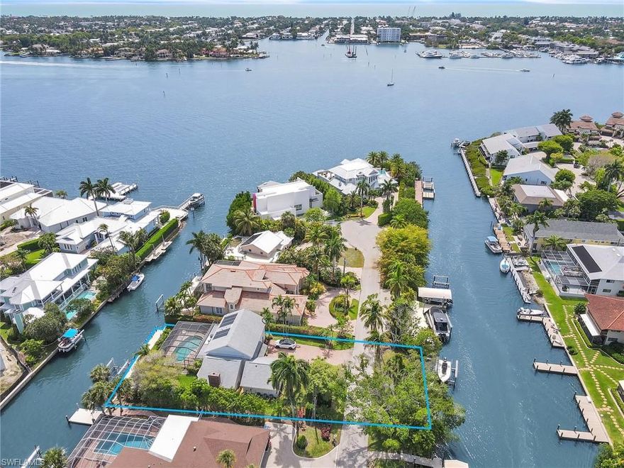 Discover an exceptional waterfront retreat in the highly desirable location of Oyster Bay. This unique property offers a total of 160 feet of water frontage, 80 ft on the southern side and 80 feet on the northern side with two private boat docks, two lifts and bridge free access to Naples Bay and Gordon Pass- ideal for avid boaters and adventure seekers. This coastal charmer offers a perfect blend of timeless style, updated interior and open living spaces perfect for entertaining. Stunning water views and endless sunrises and sunsets with preferred southern exposure. This home has been meticulously maintained throughout the years making it an ideal full time/part time residence or an incredible opportunity for redevelopment. Enjoy close proximity to Downtown Naples, world class dining, shopping and beaches.