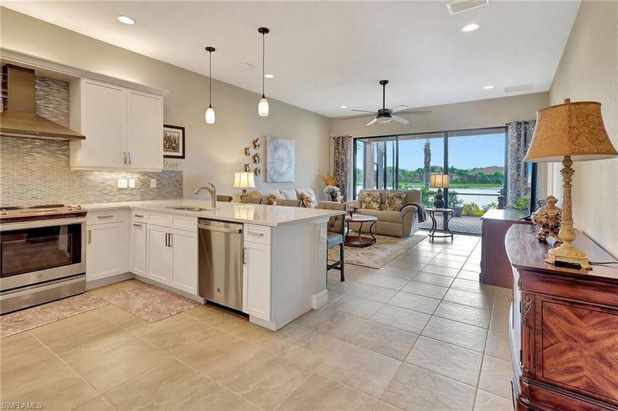 Don’t miss out on this incredible opportunity to own a gorgeous villa in the desirable Marina Bay community! Ready for immediate occupancy, this Nantucket Model villa, built in 2021, offers a spacious and open floor plan with 2 bedrooms + den (or 3rd bedroom) and 2 full bathrooms. Perfect for anyone seeking a home with ample space and comfort, this residence features split bedrooms, sizable walk-in closets, and a neutral color scheme throughout, making it ideal for any style or preference.  As you step inside, you'll be welcomed by a screened-in front lanai leading into the home's grand interior, where volume ceilings enhance the spaciousness. The separate dining room adds a touch of elegance, while the upgraded kitchen serves as the heart of the home. White cabinets, quartz countertops, a hooded range, and a stunning backsplash elevate the space, creating the perfect atmosphere for both casual dining and culinary delights. The highlight of this villa is undoubtedly the oversized extended lanai, which offers breathtaking views of the serene water with fountain – an idyllic setting for watching stunning sunsets. For those who love to entertain, the villa is equipped with a high-end built-in outdoor kitchen, making it perfect for hosting gatherings in style.  Set within the gated Marina Bay community, you’ll enjoy low HOA fees and an impressive range of world-class amenities, including a 12,000 sq. ft. clubhouse, a full-time social director, card and billiards rooms, a fitness center, and a variety of sports facilities, such as indoor and outdoor basketball, tennis, and pickleball courts. For relaxation, indulge in the community's three pools—resort-style, lap, and a children's splash pad, along with a play area for families.  Conveniently located near RSW International Airport, FGCU, shopping, dining, and beautiful beaches, this villa offers the perfect blend of luxury, convenience, and tranquility. Whether you're seeking a seasonal retreat or a permanent home, this property is a must-see!