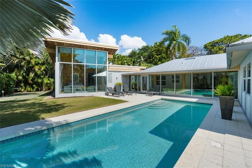 H1910 - Featured in GULFSHORE LIFE and NAPLES ILLUSTRATED this Tropical oasis in the heart of Olde Naples is an Ultra-spacious 4-bedroom, 4.5 Bath home on landscaped lot with heated pool, putting green and citrus trees. Magnificent addition complete in 2014 received the American Institute of Architects Award and features Floor to Ceiling Glassed Addition for primary bedroom overlooking private garden and pool with California closet system in 2 walk-in closets, spectacular owner’s bathroom spa and large den w built-in desk and shelving.  Main house updates in 2019 include maple hardwood flooring throughout the living space, recessed Lutron lighting system, custom finished kitchen cabinets and sparkling quartz island. Enclosed dining lanai, 2 car garage and storage room complete this extraordinary move-in ready Florida masterpiece.  Close to the amazing beaches at the gulf and Fun on 5th Avenue.  Enjoy Naples at its finest!