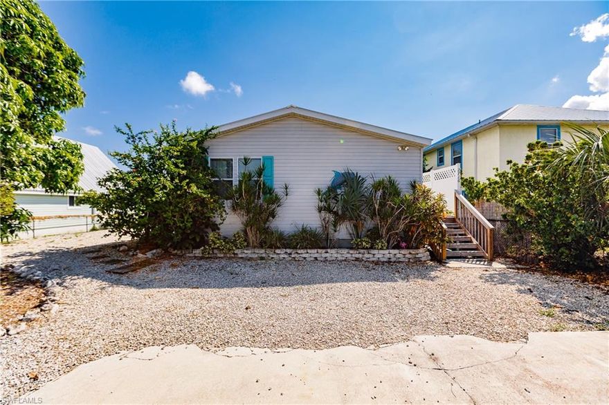 THIS IS IT!  Nothing out there with all the extras this one has.  2 Bedroom, 2 Bath mobile home on the water with a dock, lift, in-ground pool, deck, metal roof, spacious vaulted ceiling adds to the openness of the living/dining/kitchen area, screened lanai overlooking the pool and separate detached building that half of it is used for storage and half could be converted into a workshop or craft room.  In addition, this home is already established as a vacation rental so it is income producing. It is currently rented from the week of Thanksgiving through March 31, 2021.