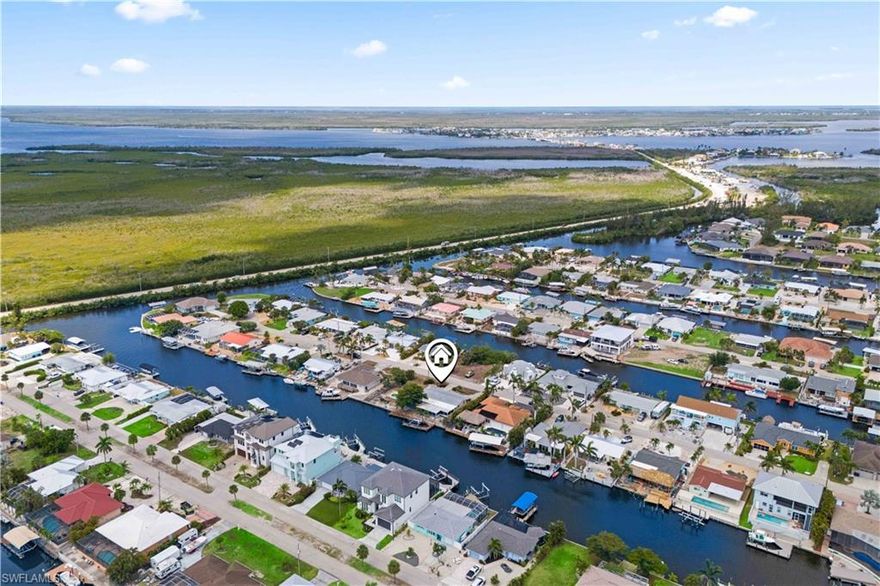 Welcome to the largest double lot in Matlacha—an incredibly rare opportunity to live on the water with wide-open views that stretch for miles. This expansive property offers unmatched space and potential in one of Florida’s most colorful and charming coastal communities. Multiple outdoor lanais and covered living areas provide plenty of room for entertaining or relaxing in the island breeze. Enjoy the pool, with ample room left to create the ultimate tropical retreat. A huge private dock extends into the water and includes a 63-foot boat dock with a 12,000 lb. capacity—perfect for serious boaters looking for quick access to the open water. The home itself has a spacious layout and good bones but would benefit from some updating. Still, it’s the lot that truly sets this property apart—double the size of most in Matlacha, with room to grow, incredible views, and endless waterfront possibilities. Don’t miss your chance to own this one-of-a-kind slice of paradise