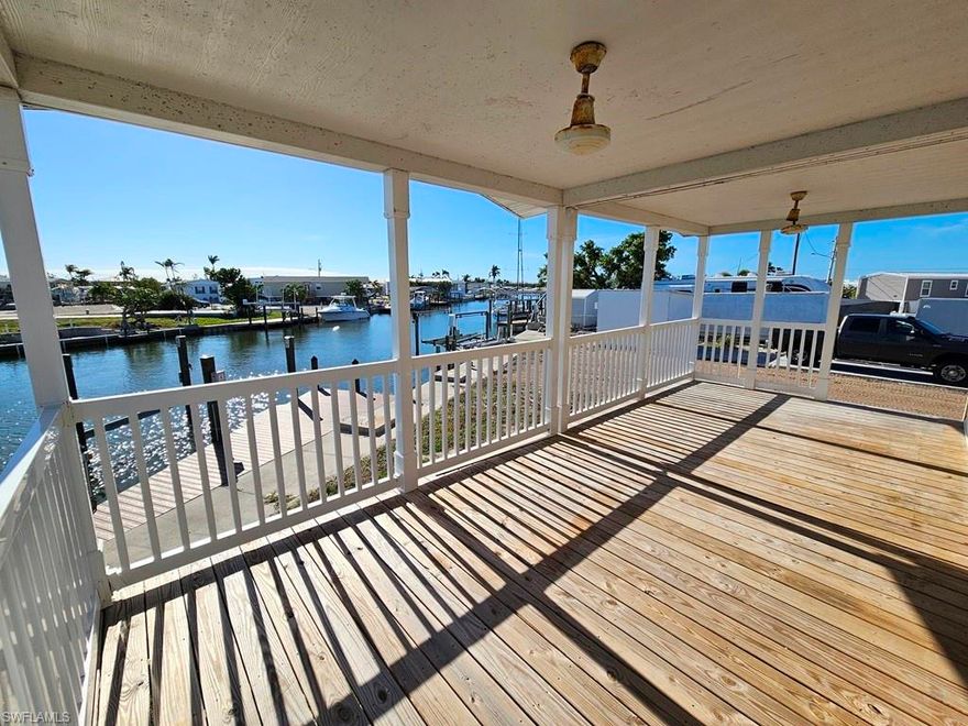 GULF ACCESS canal home located in the heart of St. James City. This 2 BEDROOM, 2 BATH manufactured home has 1,008 square feet of living space and was built in 2021. The open concept floor plan with vaulted ceilings and open kitchen makes the home feel larger than the square footage shows. Your great room opens up to your 10'x24' covered deck overlooking the canal with magnificent views of the water and those world famous Pine Island sunsets. The home is elevated to current code putting it above 9' to meet the new FEMA flood elevation requirements. You'll also enjoy the convenience of public water and sewer so no wells or septic systems to mess with and a new metal roof was installed in 2023. Your waterfront home will provide quick access to open water allowing you to enjoy San Carlos Bay, Pine Island Sound, Sanibel, Captiva, Ft. Myers Beach, Cayo Costa, etc. This home does need some work to make it the island paradise of your dreams and the price reflects the current condition. You'll be able to finish the home to your specifications and have the opportunity of built in equity when completed. The home did experience roof damage during Hurricane Ian but it DID NOT FLOOD. The home was purchased locally and moved to this site in 2023. This is a tremendous opportunity to create the home of your dreams and bring it back to "like new" condition. Schedule your showing now as opportunities like this will not last long. This same model and floor plan in "like new" condition sold around the corner on York Rd for $415,000 in Jan. 2025. Need a General Contractor to provide a quote to make your island dream home a reality? We can help there too! Schedule your showing today and bring us an offer!