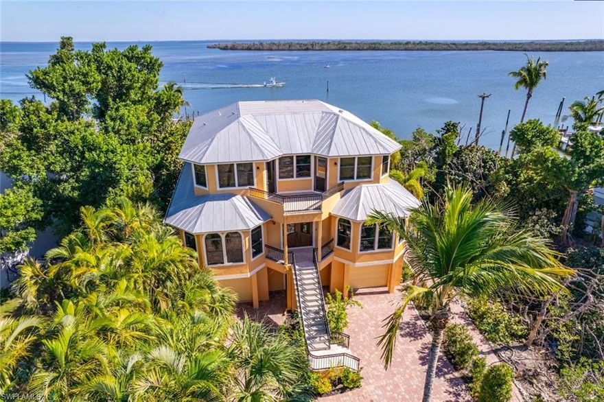 A Fantastic waterfront property along the Tween Waters area, overlooking the Bay & Roosevelt Channel on Captiva Island. This home radiates a gentle Mediterranean ambiance, enriched with Travertine marble & cherry wood flooring, tailor-made cabinetry, & top-tier Wolf kitchen appliances. The layout includes a spacious great room w/ stunning bay views, a large 2nd floor media family room, a sophisticated lutron lighting system, full house generator & water filtration system. Features also include elevator, a secure lower level, & three-car garage. Unique in its offering, this home combines the privacy & space of a single-family house with the perks of condominium living. Residents enjoy a lifestyle that spans from beach to bay, including boat docking facilities, a community pool, & exclusive beach access. The association manages external maintenance, including roofing & landscaping, plus insurance, making the cost of ownership ideal. Incredible WEEKLY RENTAL making it a fantastic income-producing investment property while you also enjoy personally. This property is a Great Value w/ stress-free, low cost, waterfront living, Boating & Beach.