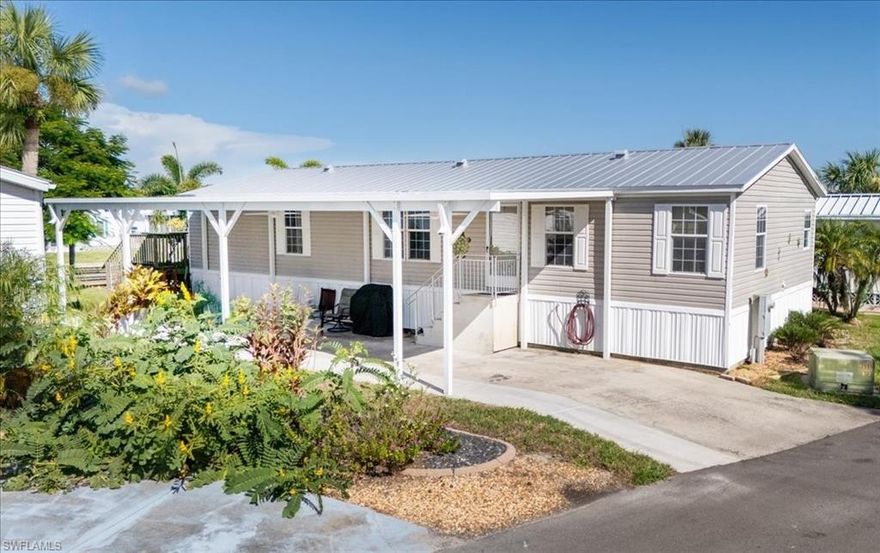 WATERFRONT–LAND OWNERSHIP-NO LOT RENT Don’t miss this rare opportunity to own a beautifully maintained 3 bedroom, 2-bath home in Pelican Harbor Mobile Home Estates, one of the area’s most desirable 55+ waterfront communities. Perfect for boating, kayaking, and fishing enthusiasts, this property delivers the ultimate blend of comfort, convenience, and coastal lifestyle. Inside, you’ll find a spacious split floor plan filled with natural light. The primary suite features a walk-in closet and ensuite bath with dual sinks, soaking tub, and separate shower. The bright, open kitchen offers ceramic tile flooring, an eat-in bar, and abundant cabinet space. A dedicated laundry room adds everyday convenience. The bonus room expands your living area with sliders that open to a massive deck overlooking the water—a perfect spot for entertaining or simply enjoying the view. Upgrades include a metal roof, new spray foam insulation underneath, and newer A/C for improved energy efficiency. Enjoy the expansive open porch—ideal for relaxing or entertaining—along with your private dock, boat lift, and seawall for effortless waterfront access. Additional features include a new 48x16 covered carport with electrical. Community Amenities: Heated pool and clubhouse, shuffleboard, horseshoes, bocce ball, designated RV/trailer/boat storage, and inclusive water, sewer, and trash services. Ideally located near shopping, golf courses, entertainment, and top-rated dining—and just an hour to the world-famous Siesta Key Beach—this home offers both a serene retreat and an active waterfront lifestyle. Schedule your private showing today and experience the best of Florida living!