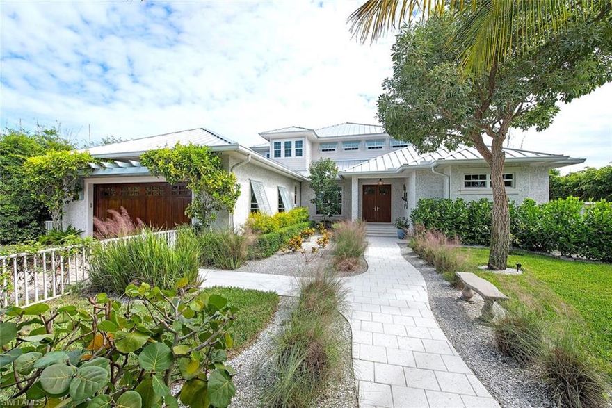 NEW BUILD in 2015!!!  Pristine condition and beautifully decorated home located on a great canal in Royal Harbor. Incredibly well thought out floor plan! The first floor has a master suite along with two guest en-suites, and office. The 2nd floor acts like a guest house with an exquisite VIP suite, open living and dining area, sweeping outdoor veranda, and an exercise studio (or 5th bedroom) with sauna and shower, for an unrivaled, in-home amenity. There are 1st and 2nd floor laundry rooms. New whole house generator with 750 gallon tank. Outside, the main level outdoor living space features a large dining and living space, a built in grill and refrigerator, automated roll down screens, and a heated salt water pool and spa. Seawall, 65' IPE dock, and 10,000 lb boat lift are all new in 2015. A spacious patio with Tiki Hut complete the rear entertaining space.  Gorgeous Coquina Shell stucco exterior adds character and charm.  This home is in pristine condition and ready to go for the next owner to walk right in and start enjoying, including being sold FURNISHED including the TESLA CHARGING STATION!!!  A rare opportunity in a great neighborhood with close proximity to downtown Naples.