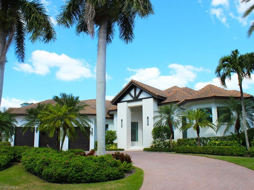 Perfectly situated in the heart of Park Shore with beautiful bay views, this stunning waterfront home is the epitome of luxury living in Naples. From its breath-taking front elevation to the lush tropical landscaping, everything about this property has been meticulously designed for the ultimate coastal living experience. Stepping through the front door and foyer reveals a bright and airy open floor plan drenched in natural sunlight. As you pass through the spacious dining area and living room, you enter the gourmet kitchen equipped with Wolf and Sub-Zero appliances, custom cabinetry, an inviting kitchen island, and sunny breakfast nook. The home offers 4 bedrooms plus a den, 5 bathrooms including a pool bath, home office, and 3 car garage. Spend evenings with the sliders open and enjoy the sunset from the covered lanai, open patio, or by the outdoor fireplace taking in the sunset skies. Your guests will love dipping their toes into the saltwater pool and spa, while enjoying a delicious poolside treat from the Summer Kitchen. Newly constructed in 2023 by Orick Marine, the composite decked boat dock is complete with a 32,000lb boat lift for enjoying your time on the water. This home defines waterfront living. Located within a short distance to the Village Shops on Venetian Bay, Waterside Shops, and Park Shore’s private beach access, all the best of Naples is just moments away.