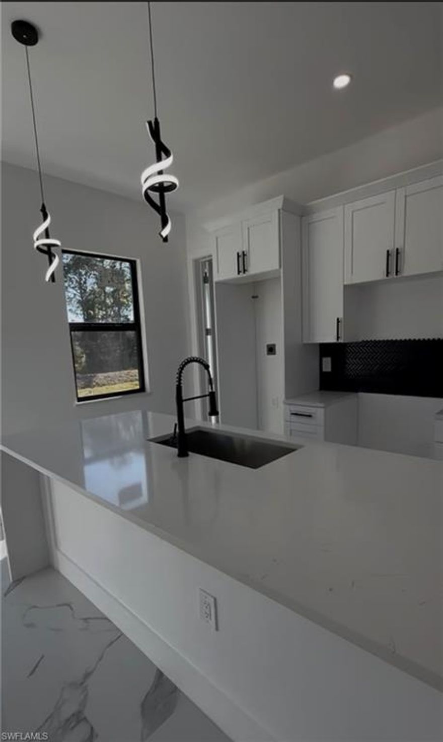 NEW CONSTRUCTION!! Fully impact doors and windows, gorgeous home in Lehigh Acres! This stunning 10ft high single-family home 3 bedrooms , 3 Full bathrooms, an open concept layout, 1-car garage, large backyard with room for a pool. Stainless steel appliances, white quartz countertops in the kitchen, washer and dryer hook up, With Tile flooring throughout the house make it stylish and easy to maintain. This home is built with the highest standards and care.