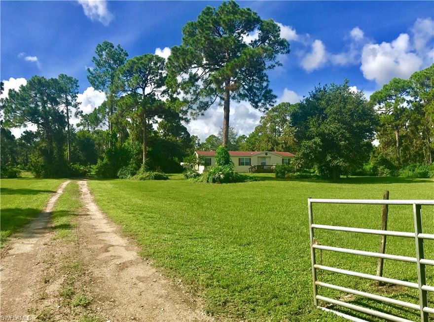 Looking for country living? This 10 acre parcel is located in Ft. Myers and is a beautiful piece of property completely fenced and crossed fenced, at the end of a private road, secluded yet not too far from town.  Large 40x40 barn with 2 stalls(plenty of room to easily add more stalls), concrete floors. Barn is partially enclosed w/ gorgeous custom built 30x15 room that is currently used as "man cave' but can be used for whatever you like, has a bar and brand new AC unit, has plumbing in place as well.  Home is well laid out 3/2 with custom closets in all 3 rooms, brand new screened back porch, beautiful stone fireplace, split floor plan, large master with dual sinks, large garden tub with jets and shower, brand new dishwasher, carpets cleaned approx. 6 mon ago.  Must see to truly appreciate!! Has a shed that is right next to barn used as a tack room/ "she shed" and has new flooring and ac unit as well.  Property is located on a corner and at the end of a road right next to a 140 acre parcel adjacent property has orange groves toward the back.  Property is off of 82 which is currently being expanded into four lanes. Don't miss out, call today to schedule your private showing!!!