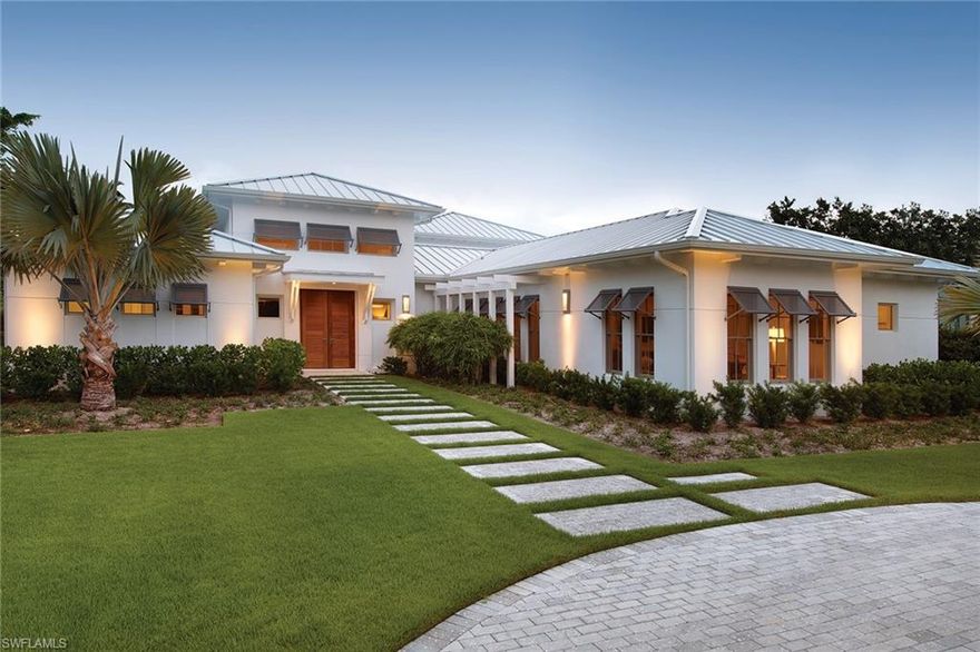 One of only 5 lots that front on Palm Circle W., going through to 3rd St. – MHK Architecture, built by Waterside Builders and brought to perfection by professional interior designer. This home was featured in Home and Design Magazine exemplifying Coastal Modernism. The meticulous attention to detail is evident & the large parcel allows for spacious indoor & outdoor living areas with 16-foot ceilings in the living room with clerestory windows, a tumbled onyx fireplace, an open floor plan with the adjoining dining room and U shaped kitchen plus a large butler’s pantry/bar area. French Oak floors, Andersen windows, high-end appliances, quartz countertops are just a few of the features. 1st floor Master bedroom, 2 additional 1st-floor en-suite guest bedrooms (one is currently used as a den) with 2 guest bedrooms upstairs with loft area & sunset balcony. An expansive outdoor area with saltwater pool & spa, summer kitchen, outdoor fireplace, pool bath & travertine deck. Located just 3 blocks to the beach and close to 5th Ave, this tropical setting blends harmoniously with nature, creating a livable and relaxed environment.