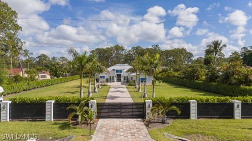 Welcome to Your Private Paradise in the Heart of Naples! Drive through the privacy gate into your own secluded oasis—2.27 acres of fully fenced and beautifully landscaped property that combines luxury, peace, and convenience. A palm tree-lined paver driveway leads you to this impeccably designed estate, offering the ultimate in indoor-outdoor living. The centerpiece of the outdoor space is a stunning custom pool with a spa, sun shelf, and dramatic fire bowls—perfect for relaxing or entertaining in a true resort-style setting. Enjoy the expansive covered outdoor living area, complete with an outdoor kitchen and fire pit, ideal for hosting family and friends year-round. Inside, the home features exquisite finishes throughout, including white oak wood floors, custom maple ceilings and beams, and a show-stopping kitchen with mixed wood cabinetry, Pompeii Venetta quartz countertops, and a large island perfect for gathering. This thoughtful split floor plan ensures both privacy and functionality. One oversized bedroom offers flexible use as a second master suite, in-law quarters, media room, or bonus space to suit your lifestyle. Tucked away in peaceful seclusion yet just minutes from Naples’ finest beaches, restaurants, and shopping, this is truly a one-of-a-kind opportunity to own a luxurious retreat in one of Florida’s most desirable locations.