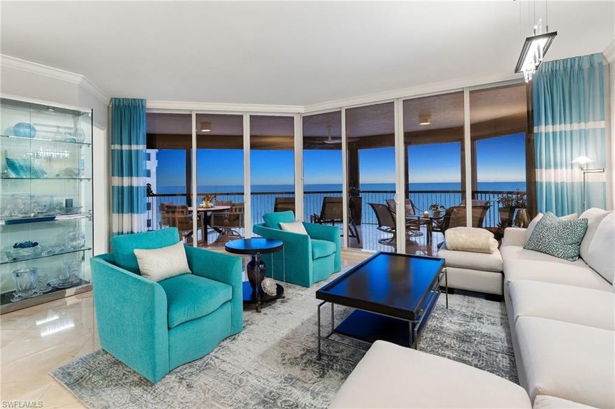 Perfectly positioned on the coveted southwest corner of the Biltmore at Bay Colony, this exceptional three-bedroom plus den residence in the sky sits directly on the crystalline Gulf coastline, offering breathtaking panoramic views. From the moment you enter, the eye is drawn through the great room to the expansive balcony beyond—an ideal setting for entertaining or simply soaking in the endless sea and sky.  Updated interiors are thoughtfully curated to reflect the serene hues of the Gulf, creating an elegant coastal ambiance complemented by the soothing sounds of the surf. The spacious, light-filled kitchen is a standout, featuring Taj Mahal quartzite countertops, custom modern cabinetry, and gourmet appliances, all surrounded by walls of glass that flood the space with natural light.  Guests will enjoy two generous ensuite bedrooms, each with access to the southeast-facing lanai—perfect for quiet mornings and soft sunrise views. The primary suite is a true retreat, offering direct Gulf views, a beautifully appointed bath, and a perfectly designed walk-in closet.  With neutral finishes throughout, abundant space for family and friends, and an ideal seventh-floor elevation capturing both beach and open Gulf vistas, this residence truly has it all.  Biltmore at Bay Colony offers a resort-style lifestyle with a luxurious pool, state-of-the-art fitness center, and 24-hour security, all within the privacy of the Bay Colony gates. Residents also enjoy exclusive access to the private beach club, tennis facilities, and more—delivering the ultimate Naples coastal living experience