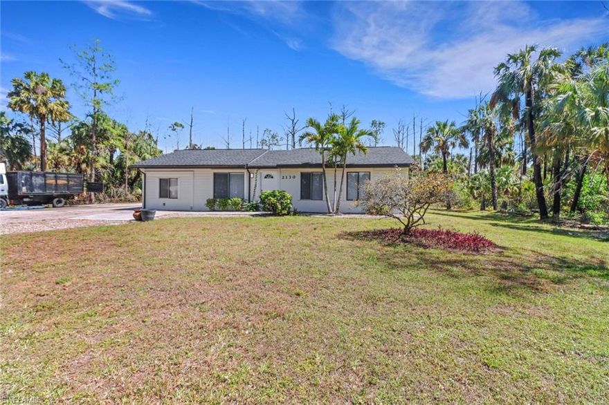 One or more photo(s) has been virtually staged, AI generated or rendered.  Exceptional location! Situated on Wilson Blvd just north of the upcoming Vanderbilt Beach Road extension, this beautifully updated 4-bedroom home sits on 2.27 private acres and offers space, comfort, and future growth potential. The home features renovated kitchen and bathrooms with quartz countertops, updated fixtures, new appliances, and numerous additional upgrades throughout. With two A/C units, including one replaced this year, and an oversized lanai ideal for entertaining and outdoor living, this property truly stands out. Now offered at an improved price — don’t miss your chance to own this exceptional property!