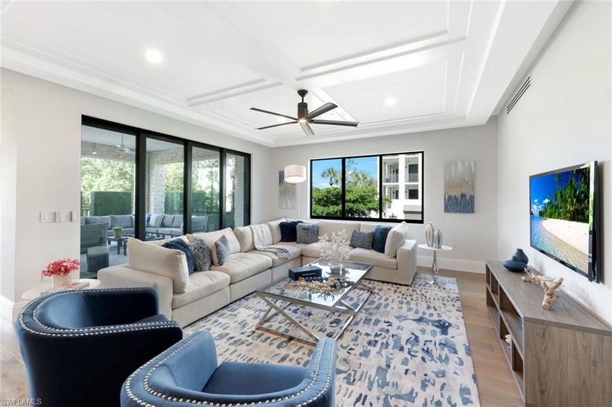 UNBELIEVABLE VALUE – MASSIVE PRICE IMPROVEMENT! Don’t miss this rare opportunity to own a luxury southwest corner home in Quattro at Naples Square—now priced to sell! Completed in 2023, this spacious 3-bedroom + den, 3.5-bath residence offers almost 3,000 sq ft of high-end living just steps from the beach, 5th Avenue South, Bayfront, and Gulfshore Playhouse.

This light-filled, corner unit is one of the most desirable in the building, featuring an oversized private lanai with sunny southern and western exposures—perfect for outdoor dining and entertaining. Inside, the open-concept great room flows into a chef’s kitchen with an expansive island that seats six, custom quartz backsplash, premium appliances, gas cooktop with exterior vent, a walk-in pantry, and thoughtful extras like a built-in breadbox and sliding spice racks.

The luxurious primary suite includes wood flooring, motorized shades, fully custom closets, and a spa-style bath with dual vanities, soaking tub, and walk-in shower. A formal dining area, custom bar with dual beverage refrigerators, private den with Italian sliding doors, and a well-appointed laundry room with sink and built-ins add to the home’s functionality and style. Designer upgrades include concealed sprinklers, under-cabinet lighting, extra outlets, and a striking powder room.

Enjoy resort-style amenities including a pool, spa, fire pit, grilling area, fitness center, and elegant club room. Pet-friendly with two garage-secured parking spaces and climate-controlled storage included. This is downtown Naples luxury at an unbeatable price—schedule your showing today!