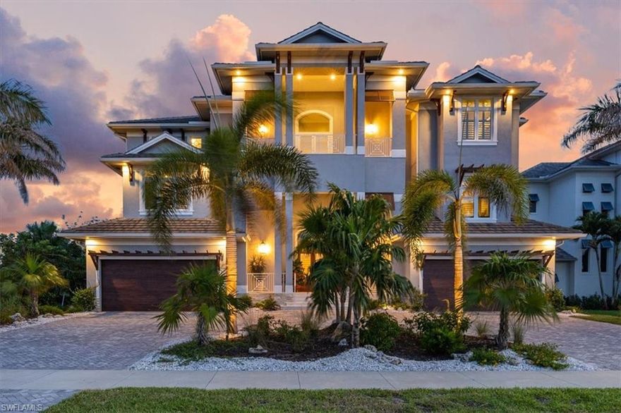 Experience extraordinary coastal luxury in this magnificent Gulf Front residence, perfectly positioned to capture breathtaking Gulf and Beach views—along with unforgettable sunsets over Marco Island. Located in the highly sought-after Tigertail neighborhood, this exceptional home is less than 1,000 feet from direct access to the Tigertail Beach access. Offering over 6,700 square feet of living space and more than 14,000 square feet total, this stunning estate is designed for both grand entertaining and comfortable everyday living. The home features five bedrooms, five full baths, two half baths, two private dens, wood-look tile, and provides ample space for family and guests alike. A true dream for car enthusiasts and collectors, the residence boasts an impressive 8-car garage, ideal for showcasing prized vehicles, housing outdoor toys, or accommodating a serious hobbyist’s needs. Thoughtfully designed to maximize the spectacular views, the main living areas open to expansive terraces on every level. The gourmet kitchen is a showpiece, featuring a spacious L-shaped island with Carrera marble countertops, Wolf and Sub-Zero appliances, a Miele built-in coffee system, and an adjacent dining area perfect for entertaining. The main living space is highlighted by a beautiful gas fireplace, built-in illuminated cabinetry, coffered ceilings, and a large balcony overlooking the shoreline. Upon entry, a dramatic cascading staircase with shell stone treads sets the tone for the refined elegance found throughout the home. The ground level offers a generous rec room, pool bath, and a custom-designed resort-style pool and spa with beach entry and built-in table—ideal for relaxing or entertaining. Relax by the pool and entertain with the outdoor kitchen.  Offering an oversized, fully fenced backyard make this property perfect for dog lovers, offering plenty of room for pets to run and play in privacy. The second-floor features four additional bedrooms, including a second primary suite, a family/game room, dog watering system, and a den. Elevator access to all levels, laundry facilities on every floor, and abundant storage throughout enhance the home’s comfort and functionality. This exceptional Marco Island estate seamlessly combines luxury, lifestyle, and location—an unparalleled opportunity to enjoy coastal living at its very best.