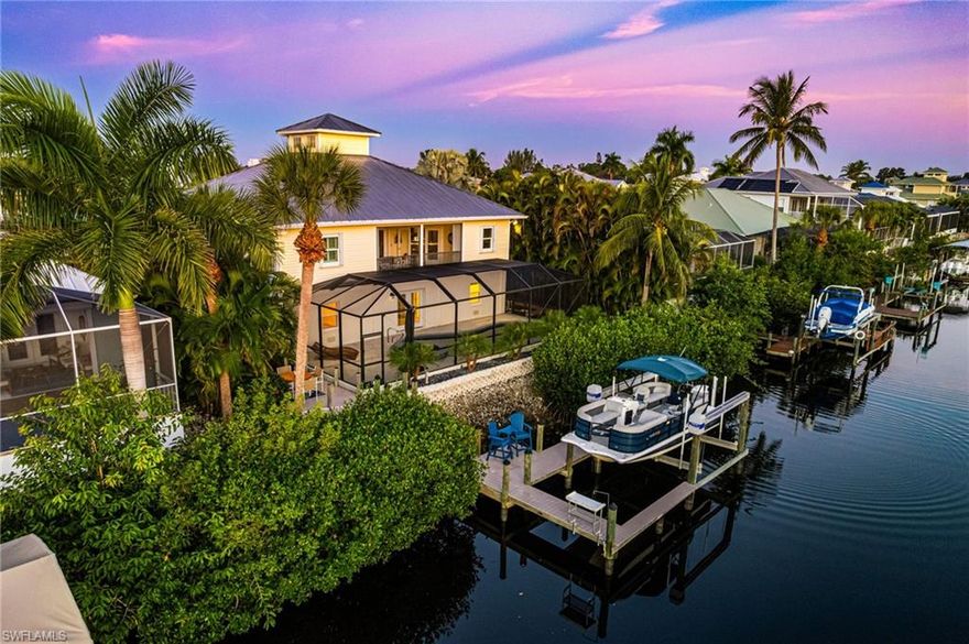 NAVIGABLE  & SUSTAINABLE. Welcome HOME to your GATED, BOATERS PARADISE on the Imperial River canal boasting a 13,000lb boat lift! This updated Key West-style stilt home is 1 of only 40 custom homes designed for waterfront living at its finest. THINKING of INVESTING? Enjoy the benefits of a 3-year proven annual rental history up to $94K.  A full-width front porch that spans the entire front elevation sets a charming southern tone, inviting you into sun-filled interiors where walls of windows and glass doors showcase the home’s bright, airy character up to a 3rd-story cathedral-lit ceiling of skylight windows.  The lower level includes potential for a living/game room or 4th bedroom (this is NOT counted in the home’s living sqft). Your 4-car tandem, deep garage will hold ALL of your WATER TOYS, allowing you to enjoy kayaking, canoeing, & fishing—all from your own backyard. Concrete block 1st floor.  INSIDE: Warm, light wood-look LVP wide plank flooring flows seamlessly through the main living spaces, leading to a comfortable kitchen equipped w/stainless appliances, granite surfaces, abundant cabinetry, a counter bar peninsula w/in-line sink, & an oversized walk-in pantry w/generous shelving.  Bring the outdoors in w/3 SEPARATE OUTDOOR AREAS! The elevated 2nd-story rear lanai connects to the great room thru 2 double French doors. The elevated lanai offers sweeping views of the sparkling POOL, BOAT DOCK, & serene 80’ wide boaters-dream NAVIGABLE 6-8ft CANAL. The split-bedroom design provides privacy for all. The owner’s suite (tucked on the SE corner w/stunning sunrise views) features lanai access, dual closets, & a spa-inspired bath w/dual vanities, separate tub, & shower. 2 guest bedrooms open directly onto the expansive open front porch for exceptional sunsets to enjoy sipping a beverage on rocking chairs. 1 guest bedroom has an en-suite bath that is also accessible for entertaining. The 3rd bedroom creates the perfect work-from-home office or den.

Downstairs, the LOWER LEVEL delivers 1,200 sq ft of ADDITIONAL BONUS AREAS for endless possibilities for additional interior living spaces as desired—exciting potential to create a game room, lounge, or additional hangout space (not included in the upstairs square footage). The extra-deep, 4-car garage easily accommodates multiple storage needs for vehicles, kayaks, paddleboards, & all your water toys.

Outdoor living shines here w/a recently completed pool renovation—including a new pump, updated lighting, & a luxurious $35K pool deck/dock overhaul—creating a true waterfront oasis. Launch your kayak, go fishing, or simply unwind on the COMPOSITE boardwalk as the river drifts by.

Additional upgrades such as new ductwork through the 3rd bedroom & a 2022-installed 4-ton 2nd-floor HVAC enhance comfort & efficiency. With room to play, spaces to relax, & direct access to the scenic intercoastal-connected Imperial River, this home embodies the Florida lifestyle.

Your waterfront retreat awaits!