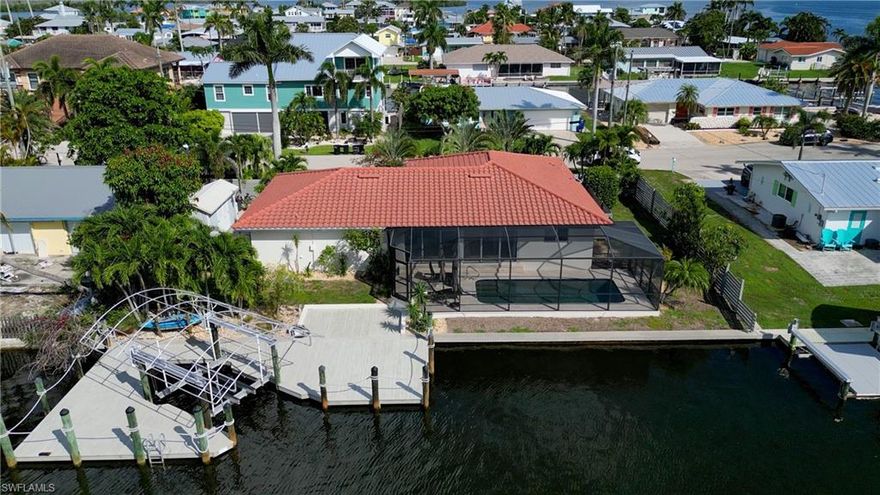Perfect Opportunity to Customize a Well Built Matlacha Home! This home sits on 100ft of deep-water Gulf access and is the second home from Matlacha Pass which provides open water views! Matlacha is a waterman’s paradise surrounded by world class fishing, pristine beaches, abundant native wildlife and offers access to the Great Calusa Blueway Kayak Trail. Everything Matlacha has to offer, including restaurants and shops, is just a short walk or bike ride away. This open floor plan 3-bedroom 2 bath home is ready for you to personalize but is loaded with tons of upgrades to build upon! As soon as you walk into the home you are met with a panoramic water view through the 20ft of impact sliding doors that line the back of the expansive great room area which is the central hub of the home. There are impact windows and doors throughout this home. The large open kitchen is ready for you to customize and also offers views of the canal and Matlacha Pass. The master suite also offers a water view and features a walk-in closet and an oversize jacuzzi. Your guests will be spoiled when they visit with the spa like guest bath that features a Koehler steam shower! The steam shower has beautiful tile work, glass doors as well as a natural green beach pebble floor. The interior of this home includes a large laundry area and a finished garage that the owner used for a recording studio. They always say they don’t build them like they used to and that definitely applies to this home! The roof structure is over-built with plank construction instead of plywood which makes it incredibly strong. A new water barrier and tile roof was installed in 2014 offering many years of roof life (Typical tile roof life is 40-50 years). Third nail was installed to help with insurance discounts as well. The roof has weathered multiple storms with no issues. The outside spaces of this home really make it something special! The screened pool area is the perfect place to take in the beauty of Matlacha, including breath taking sunrises and sunsets or dolphins and manatees that cruise by daily. The pool has been renovated with new tiles, a pebbletech surface and is a heated saltwater system. The pool enclosure has also been updated and features a travertine pool deck. The almost 900 sqft dock is a fisherman’s dream featuring a dual cable 10k covered boat lift complete with remote (cover is currently being stored in the shed). The property itself features lush tropical landscaping including your own mango tree, a custom fence for privacy, a Tuff shed for extra storage and black river stone accents throughout. As a HUGE bonus a Generac Generator has been installed with a 600-gallon propane tank. Home features 2 AC systems as well, one for the main home and one for the finished garage (currently detached). Make sure to view the drone link to see the stunning surroundings of this home! Now is the time to get into Matlacha....Come see this home today and start Living the Island Life!