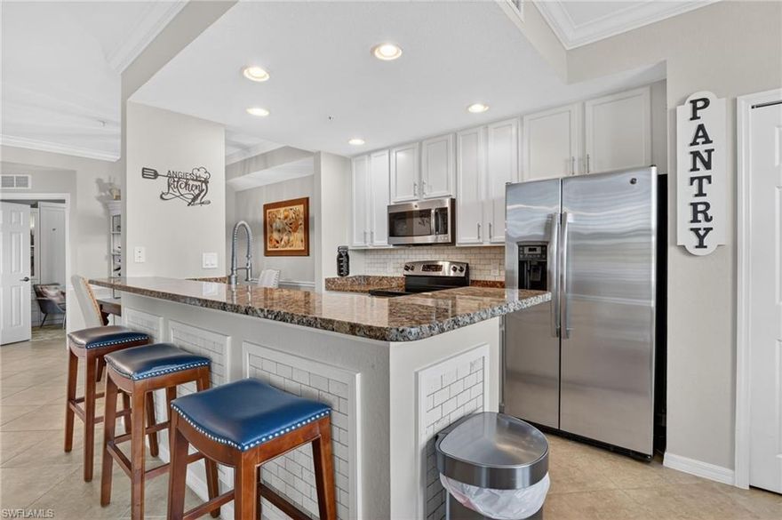 Welcome to an exceptional opportunity to experience resort-style living in the prestigious community of Treviso Bay, where every day feels like a private escape. This beautifully upgraded first-floor veranda with a coveted social membership offers serene water views, coastal charm and amenities that dazzle.
Inside, the residence brings understated elegance with warm designer tones, classic wainscoting and thoughtfully curated finishes throughout. The bright, coastal-inspired kitchen showcases crisp white cabinetry, a view over the water, and a charming breakfast nook—perfect for morning coffee or a quiet retreat. The open-concept living area flows seamlessly to the screened lanai, where the soft natural light creates a peaceful, luxurious ambiance. The den is both functional and stylish, featuring a custom Murphy bed with illuminated cabinetry, ideal for hosting guests with ease.

Life in Treviso Bay is defined by its world-class amenities, centered around the renowned Club Rilassare—an indulgent, resort-style oasis featuring a lagoon pool, spa, poolside dining and bar service, state-of-the-art fitness center, and a full-service luxury spa. Residents enjoy an active yet refined lifestyle with tennis, pickleball, bocce, and beautifully maintained grounds designed for both recreation and relaxation. The elegant main clubhouse offers upscale indoor and outdoor dining, social spaces, and a vibrant calendar of events, while the private TPC Treviso Bay course provides seasonal access for social members.

Perfectly positioned just minutes from the world-class dining, shopping, and culture of Fifth Avenue South, the white-sand Gulf beaches, and Marco Island, this residence delivers the ultimate blend of luxury, leisure, and location.