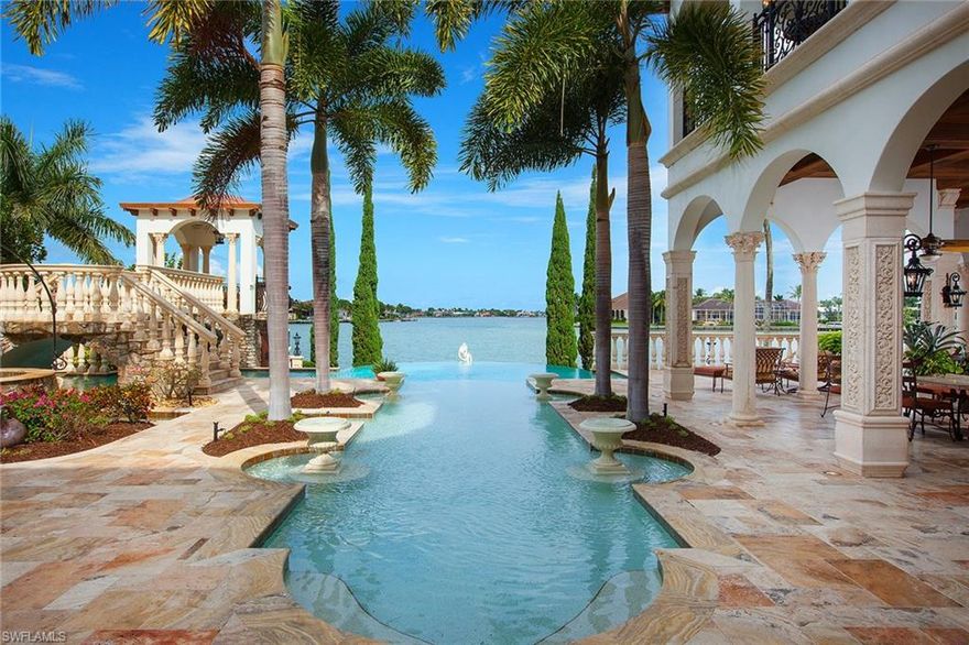 The address is coveted. The legacy is yours forever. Villa Venezia, one of Marco Island's most notable, treasured, multiaward-winning waterfront properties, is the epitome of resort-style magnificence. Its timeless elegance and ceaseless vision, together with resort-style amenities, make this palatial masterpiece awe-inspiring. No expense or time was spared in creating this architectural work of art. Located on the prestigious Caxambas Island on a deep, 1-acre, bayfront lot set against a stunning backdrop of serene bay views and beautiful landscaping sits this romantic estate with gated entry. The grounds set the tone for what this residence offers, which takes you back to the 16th century in Venice where grand Italian villas were built. This seven-bedroom, seven-full and two-half-bath residence with detached one-bed, one-bath guest quarters with fitness center spans over 14,000 air-conditioned square feet. One of the most notable features of this home is the dramatic, expansive lanai with summer kitchen, fire pit, numerous fountains, water features, bridge and a beautiful negative-edge pool. Quick, deepwater direct access from your dock. One of the most captivating homes on Marco.
