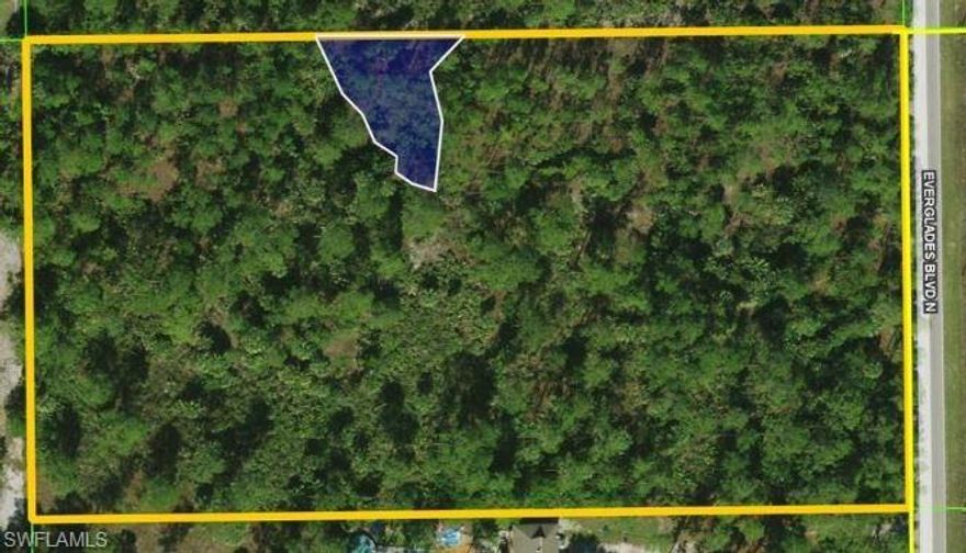 Ready for you to build your dream home on this peaceful lot in Golden Gate Estates with NO HOA and NO RESTRICTIONS. Plenty of room to roam on this Western exposed 5.78-acre wooded lot, which is 97% uplands with beautiful mature pine and palm trees.   Features room for more than one house, or you can build a stable for your horses as zoning allows 2 per acre!  Enjoy the best of both worlds in this serene setting, also within driving distance of SWFL's gorgeous white sandy beaches, as well as world-class shopping and dining.