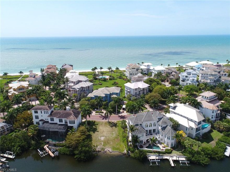 A very rare opportunity to purchase a bay lot in Barefoot Beach's Bayside community right across from the beach.  This is the only remaining lot in Bayside, an exclusive waterfront enclave of 11 luxury bay front homes within gated Barefoot Beach.  Conceptual plans for a 4 story home by RG Designs include 5 bedrooms or 4 plus den, 5.5 bathrooms, large open floor plan with covered and open lanais to the elevated swimming pool, bay views from nearly every room and sunsets from top floor deck. Premier boating with room for a double dock in your back yard no bridges and quick gulf access plus walk across the street to the beach via dedicated beach access. Barefoot Beach is gated and patrolled beach to bay community with brick pavered royal palm lined streets.