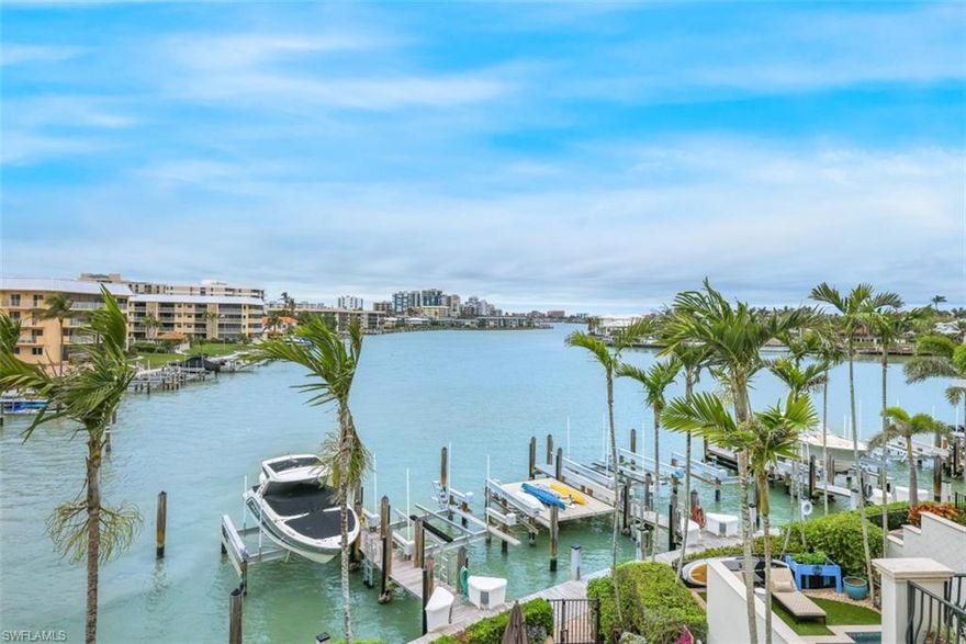 C8452-Located prior to Moorings Bay bridge headed W to Gulf Shore Blvd beaches and a short health walk to Via Miramar beach access/parking or cycle to Moorings residents private beach park (w/facilities)! Outstanding attached single family tri-level townhome, within intimate gated community, features long, vast, wrap around waterfront views plus evening city lights of Naples Bay from W sunset views to E sunrises! Open kitchen features Wolf gas stove, Bosche and Sub Zero appliances, breakfast bar and living room wet bar w/wine cooler plus balcony to take in the views! Gorgeous, natural shell-stone flooring. Large master on 3rd level has balcony as well w/remodeled bath, jacuzzi tub, bidet & separate vanities! Remodeled baths/closet organizers within all 3 ensuite bedrooms. Family room (ground level) boasts wet bar w/dishwasher, remodeled full pool/spa bath, den (has closet) and 3 stop elevator, all on/off light system & 2 car garage. Private 42' boat slip presently hosts jet skis and kayaks! Enjoy Moorings Golf & Country Club, Venetian Village shops and beautiful beaches nearby. Lock and leave comfortably while traveling. Bask in a Naples happy/healthy lifestyle within Vista Royale!