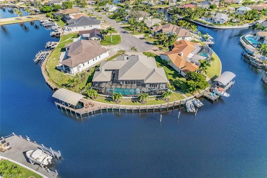 Waterfront perfected describes this 2018 Wyman Stokes 5-bedroom coastal luxury specimen property. BEST boating lot in Town and River Estates! BEST lot based on tranquil cul-de-sac, most desired SW exposure, 214ft-wide turnaround yacht basin, 5 intersecting canals, 189ft of new seawall, 175ft of new dock, 20k lb covered boat lift, dolphin pilings, PWC dock, deep navigable water via main channel to river, and convenient traffic light access from McGregor Blvd. Look at the photos, watch the video tour, and GET HERE! Fine details to look for while viewing photos include pecky cypress ceiling beams, gas cooktop, interior sliding glass doors that pocket, full bath in office bedroom, massive master closet, free-standing master tub, pavilion-style outdoor living area complete with mini-split system, picture window pool cage, oversize spa, outdoor shower, pool bath with access to air conditioned garage, water filtration system, lightning protection, and circle drive. Model home designer furnishings are included.