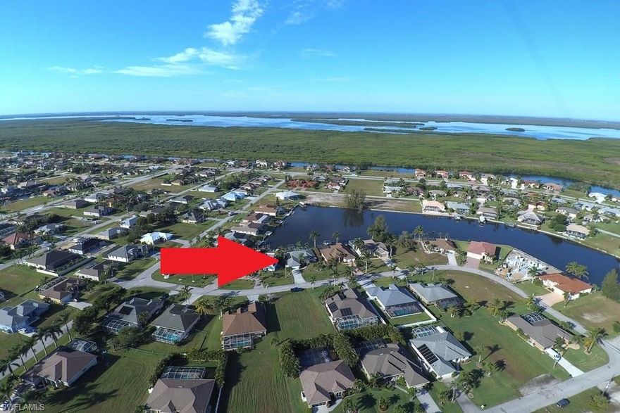 The absolute epitome of Southwest Florida living! Gorgeous sunset views await overlooking the Faye Canal Basin, offering over 380 feet in width at its widest point from your yard! There is no home for sale anywhere else in SW Cape Coral that offers this large of a water view anywhere near this price point! It gets even better... Your sparkling pool is perfectly positioned with Southwestern exposure, solar heat as well as electric for those cooler "winter" nights. For the boaters out there, you'll find an expansive concrete dock, wooden captain's walk, lift and only 1 bridge before you're in the SW Spreader canal on to the Gulf of Mexico! This beautiful 3 bedroom, 2 bathroom home offers 1,938 SF of interior living with multiple sets of sliding doors leading to your large covered lanai and pool.  2 sets of sliders are pocket sliders! Inside you'll find a formal living / dining space, split bedrooms, and a large family room off the kitchen / breakfast nook.  All living areas and the master suite offer direct water views! Did I mention that this home is impeccably maintained and move-in ready! If you're looking for the WOW water view, you won't find a better one out there for less!