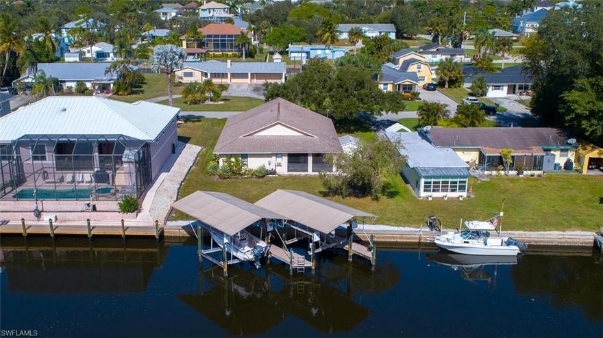 Charming waterfront home with spectacular Southern exposure, two private Gulf access boat slips & ONLY A 5-MINUTE BIKE RIDE TO BAREFOOT BEACH! Fantastic waterfront investment opportunity with no rental restrictions allowing you to secure strong rental income while going through planning & permitting to make this your dream home! This residence is a beach & boater’s dream with incredible dock setup including two 10,000 lb. covered boat lifts installed by Stokes Marine. Coveted Southern exposure ensures gorgeous natural light, breathtaking sunsets & prime sun on your future dream pool. This perfectly located home is ready for you to add your touch to make it your perfect dream home on the water. Prime location West of US-41, close to casual & fine dining & easy access to RSW Airport, the Promenade, Mercato & Waterside Shops. Only 15 miles to Naples 5th Avenue South.