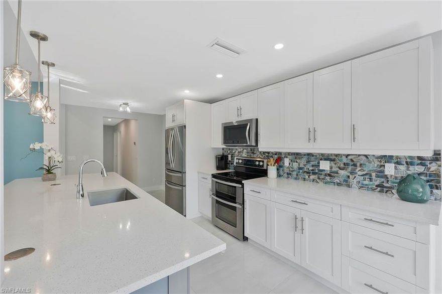 Set behind a gated entrance on 1.13 fenced acres, this beautifully renovated home offers a rare blend of value, modern style, privacy, and freedom in Golden Gate Estates. Located on White Blvd just east of Collier Blvd, the setting is immersed in nature while remaining close to everyday conveniences.  The open kitchen anchors the home, featuring quartz countertops, a large center island, shaker cabinetry in soft coastal tones, stainless appliances, designer lighting, and a striking glass tile backsplash. Tile throughout, the space flows effortlessly for gathering, entertaining, or quiet mornings at home.
Bathrooms have been fully updated with clean modern finishes, frameless glass showers, large format tile, and sleek vanities.  A long private drive leads to a generous cleared yard framed by mature trees, offering endless possibilities for a pool, guest house, workshop, or simply room to breathe. The fenced acreage provides both privacy and flexibility rarely found this close to town.  No HOA. No restrictions. Close to excellent schools, Founders Square, and major corridors. A move-in ready acreage home that delivers both style and space in a location that truly works.