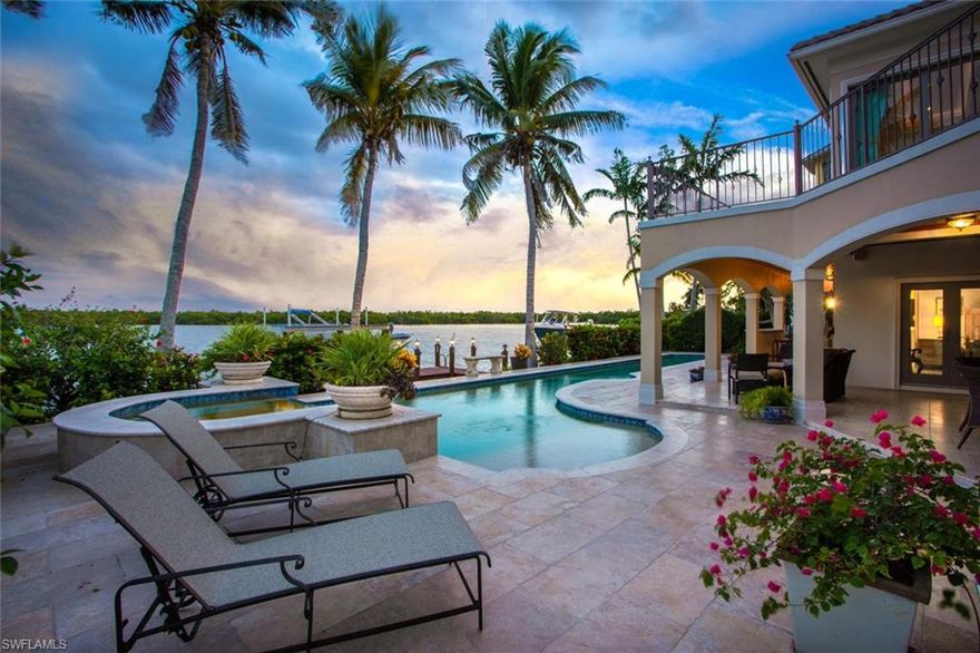 Newer-built custom Gulf access dream home with 100 ft of Bay frontage & one of SWFL’s finest views. Best of both worlds, beach & boating! Located in the Carolands, a peaceful neighborhood a short walk to the Gulf of Mexico (Bonita Beach). A scenic 5-min boat ride to the Gulf, with some of the deepest water access in SWFL, from your 20K lb boat lift. When not enjoying the warm Bay waters, take a dip in the large saltwater lap pool in the lush outdoor entertainment area with summer kitchen, grill & several seating/dining spaces all overlooking the Bay, a view that will never tire. Spectacular craftsmanship from the concrete block construction, to the whole-house storm impact doors/windows, to the soaring ceilings & ample natural light pouring through large windows. Open floor plan that lives all on one level, with a separate mother-in-law or guest suite, perfect for hosting with complete privacy, plus a 4-car garage, rec room/flex space & private elevator. This home exudes elegance with a light/bright neutral palette & custom upgrades including marble & hardwood floors, 4 new A/Cs, gourmet kitchen, wine room & finely-appointed marble-set baths, all centered around the Bay views.