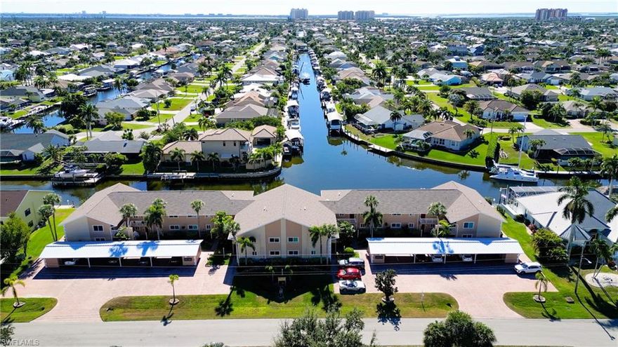 Boater’s dream with direct, no-bridge Gulf access. This spacious second-floor two-bedroom condo is perfectly positioned on intersecting canals, offering some of the most desirable water views in the complex. Watch manatees and dolphins pass by daily while enjoying quick and effortless access to the Gulf.

With over 1,300 square feet of living space and being an end unit, the condo offers enhanced privacy and the home is filled with extra natural light and showcases southern exposure, cathedral ceilings, and an open, airy layout. Water views can be enjoyed from the primary bedroom, living room, dining area, kitchen, and lanai, creating a seamless indoor-outdoor waterfront experience.

Offered fully turnkey, the residence is move-in ready with thoughtful updates throughout, including a new roof (2024), recently cleaned and sanitized HVAC system, whole-house water filtration, new interior paint, new window treatments, and a new washer. The primary suite features a large walk-in closet, and the home is well-equipped with impact glass windows plus fabric hurricane screens on the lanai for added peace of mind and the condo also comes with a handy storage unit and covered parking .

The well-maintained condo community boasts strong financials, and the building has been recently updated. Set in a quiet, peaceful neighborhood, yet conveniently located within walking distance to grocery stores, restaurants, and everyday essentials.

Whether you’re seeking a full-time residence, seasonal retreat, or an exceptional boating property, this condo delivers the perfect blend of waterfront views, boating access, comfort, and convenience.