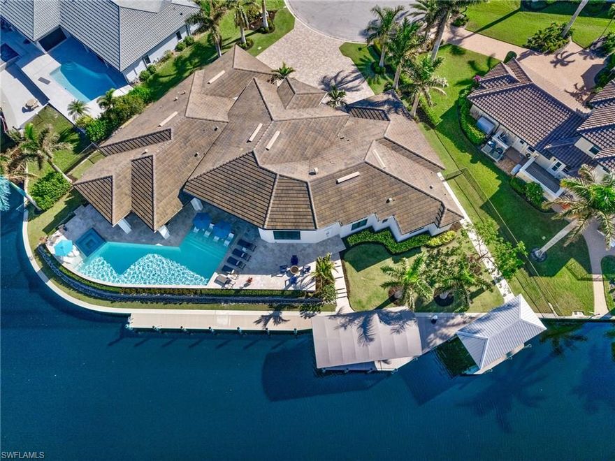 Welcome to 941 Wittman Drive.  This spectacular 4,400 sq. ft. estate, built in 2020, offers 4 bedrooms, 4 full baths, 2 half baths, and a den, all perfectly situated on 230 feet of direct-access waterfront at the intersection of two serene canals. Nestled on a quiet cul-de-sac in one of Southwest Florida’s most sought-after boating communities, this home is truly a masterpiece. Close to shops, restaurants, schools and 15 min from the beach and RSW.

Step inside and be captivated by the spacious open floor plan, soaring ceilings, and exquisite custom details throughout. The main bedroom wing is a private retreat, featuring a luxurious bath with his-and-hers water closets, a freestanding tub, an oversized shower, a workout room, and a dream custom closet.

For the culinary enthusiast, the gourmet kitchen is a showstopper with Sub-Zero and Wolf appliances, gas cooking, a waterfall-edge island, and a custom walk-in butler's pantry complete with a beverage station and built-in coffee maker. Each bedroom offers its own private ensuite bath, ensuring unparalleled comfort for family and guests.

Outside, experience the best of the Florida lifestyle with breathtaking water views, a resort-style pool, an huge outdoor kitchen with built in grill, ice maker and beverage fridge, a cozy outdoor living room with a gas fireplace, and a fire pit area for unforgettable evenings. Boating enthusiasts will love the newer dock and seawall, plus two covered boat lifts (16,000 lb. and 8,000 lb.), ready for your next adventure on the water.

This is a one-of-a-kind estate that must be seen to be believed! Don’t miss this rare opportunity—schedule your private showing today and make this extraordinary property your forever home!
