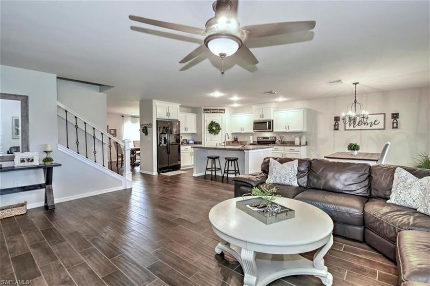 Beautifully renovated 2 story home in highly desirable Cape Coral neighborhood. Enter from the charming front porch into your Florida Farmhouse dream. Over 2,800 sf with wood plank tile throughout the first floor. Kitchen overlooks large family room with deep basin sink, upgraded fixtures, eat-in kitchen, large pantry, and newly painted cabinets.  First floor den acts as fourth bedroom with a full bathroom on the first floor. White cabinets and solid surface counters. The updated staircase leads to a huge upstairs loft that is the perfect bonus space for your media room, play room, or office. Large master bedroom offers ample natural light & vaulted ceilings with newly renovated master bathroom including custom glass door, subway tiles, and new fixtures with a private toilet and large walk-in closet.  Large 2nd and 3rd guest bedroom with shared full bath upstairs. Second floor laundry for convenience.  Relax in your recently added western exposure paver patio with sunset views, cooling fans, an outdoor sun/bbq area.  Fully fenced backyard with room for boat storage and/or a pool.  Great location close to Strausser BMX Park and community boat ramp with access to fresh water lakes.