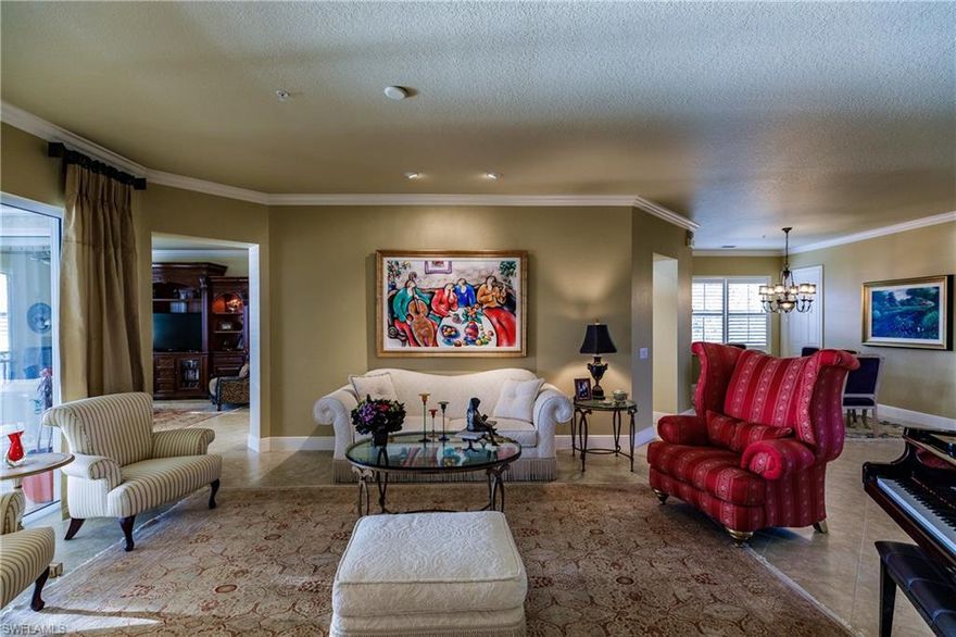 Sensational opportunity! This home is an unexpected collection of high-end finishes, lavish furniture and upscale decor, with an exquisite lake view! An elegant second floor, three bedroom plus den coach home awaits you and effortless living. This home exudes luxury living and is surrounded by amenities you would want and expect from a prestigious community. Call today to see this one-of-a-kind luxurious home. Finishes include crown molding, beautiful Natural Walnut hardwood flooring, designer chandeliers with accent lighting, plantation shutters, Marble Inlay in upper entryway, stainless steel appliances and more! New A.C. system is only four months old as of 1/1/19! List price includes furniture with a few exceptions. This desirable community of Fiddler's Creek is positioned between the sandy beaches of Naples and Marco Island and just a short drive to either! The community includes a state of the art amenities center as well as optional beach, boating and golf memberships. This home is a must see!  Call today for a private showing!