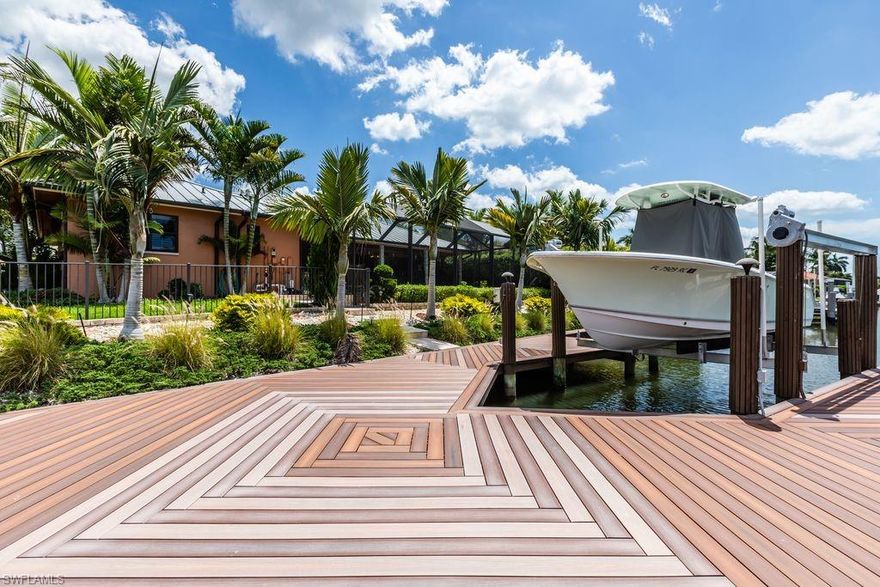 Move right in and enjoy this completely renovated gorgeous waterfront pool home on tropical Marco Island with sunny SW exposure. NO HOA or extra memberships or fees required! Quick boat ride to the Marco River and the Gulf of Mexico. Over $300k in exquisite renovations including all new plumbing pipes, new 50 year metal roof, impact glass windows and sliding doors, new bathrooms, new kitchen, new floors, crown molding, new huge dock, lift, pool cage with "picture window" full size screens. Immaculate 2 car garage with storage and extra fridge. Beautiful manicured professional landscape featuring mature tall palms, topiaries, egg river rock, stone pathways, terracing, soft zoysia grass, and numerous special features. Ring doorbell and camera security system outside. Impact glass throughout saves on utility bills and ensures a quiet indoor experience - no noise from traffic. Circular driveway with extra spot for ease of parking. Fully fenced yard. This is the perfect home - big value, manageable size, you will love it!