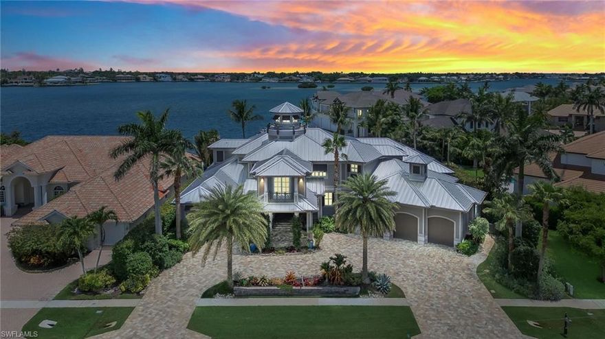 This breathtaking luxury home on stunning Robert's Bay of Marco Island is sure to enchant you.  Built in 2014 with every architectural and structural design of highest quality, this 7,000 square foot home sits on .43 acres and shows its coveted southern exposure beautifully on its expansive lanai.  There are extensive luxury home amenities throughout this entire property that are to be treasured.  It is delightful to pull up to the home under the completely covered Porte Cochere and to enter into a sprawling, 3-story foyer, see a spacious open kitchen and living room, gas fireplace, wine room, a separate social room and bar, making a perfect design for any size gathering.  The first floor includes a 4-car air conditioned garage (with high ceilings to have ability to stack multiple cars), an office and a master suite with an oversized bathroom having his and her toilet rooms, closets, and its own laundry room.  The second floor can be reached by stairs or elevator access and there you will find 3 bedrooms, a wet bar, storage closet and a gym/lounging area.  The second floor leads into its own lanai and a spiral staircase takes you to the third floor lanai with its own outdoor storage space. In addition to a full pool bath, there are 4 additional full bathrooms and 2 half baths throughout.  As a real treat there is an oversized first floor ''bonus'' room that could be used for anything you may wish such as a media room or another master suite; it has its own cooling system and exterior entrance.  This home provides direct access to the Gulf with spectacular first, second, and third floor wide water views, all with 10-foot high sliding glass doors.  The expansive lanai includes two living spaces, outdoor kitchen, barbeque, infinity pool and hot tub.  The entire lanai offers electric hurricane/security shutters and the entire home includes impact-rated windows.  This magnificent home is what dreams are made of. Here is where you will find everything you want and more in a luxury home.