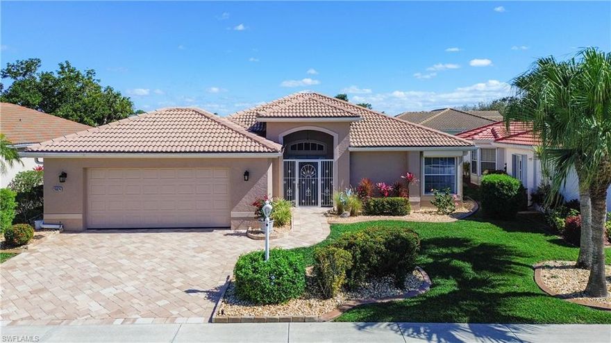 Amazing LAKEFRONT Villareal home in HERONS GLEN COUNTRY CLUB has an updated, laid back feeling, and the most SUBLIME VIEWS through the sliding doors and from the spacious expanded lanai. The living area is bathed in natural light from a skylight, and the 18-in tiles accentuate the spaciousness of the great room. Crown molding, a custom room divider and versatile lighting make it a modern and elegant space. There is a large kitchen with eat-in area, and TWO MASTER SUITES, each with a WALK-IN CLOSET. The bathrooms have both been TOTALLY RENOVATED with custom vanities and linen closets and there is a sunny, spa-like shower in the primary master en-suite, offering the perfect retreat after a long day of enjoying the community’s many amenities. A DEN with double doors makes an ideal office or craft room. Your favorite space however, is going to be the oversized COVERED LANAI with PICTURE WINDOW SCREENS to maximize the AMAZING VIEW of the large lake and golf course. The home exudes curb appeal with a paver driveway, stone mulch, 2021 EXTERIOR PAINT, and an EXTRA-WIDE GARAGE. There is a 2022 new A/C, hurricane shutters throughout and a NEW ROOF was installed just weeks ago!