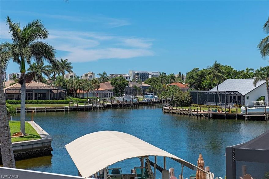 Welcome to a boater's paradise! This stunning two-story waterfront home offers gulf access and breathtaking intersecting waterway VIEWS, perfect for relaxation and entertaining. With a southern exposure SUNNY saltwater pool and spa that are designed for all-day sun and a beautiful waterfall feature, you'll have your ideal outdoor oasis. Inside, the home features 4 spacious bedrooms each with an en-suite bath plus a versatile den, two half baths (one dedicated pool bath), and a two-car garage. Soaring ceilings and expansive windows fill the space with natural light, while new impact doors and windows provide both aesthetic appeal and storm protection. The chef's kitchen is outfitted with elegant white shaker-style cabinetry, quartz countertops, and a stylish tile backsplash. Top-of-the-line appliances include an electric cooktop, double wall oven, microwave, refrigerator/freezer, and dishwasher. The cozy breakfast nook, with its bay window overlooking the intersecting waterway, is the perfect spot to enjoy your mornings, while the formal dining area flows seamlessly into the airy great room, which features glass sliders that open to the expansive lanai. The private owner's suite offers serene water views and direct lanai access. The luxurious en-suite bathroom features pocket doors, a double-sink vanity, a walk-in shower, a soaking tub, and a spacious walk-in closet. Upstairs, a staircase leads to a loft area with an open balcony overlooking the intersecting waterway with SUNSETS and the colors of the sunset glimmering off the water. Three generously-sized guest suites, each equipped with en-suite baths, ensure that your visitors have plenty of comfort. Designed for maximum enjoyment, the screened lanai includes a covered seating area, an outdoor kitchen with a sink and shower, making it an ideal space for entertaining. Boaters enjoy boating through the prestigious Estates and Caxambas Pass to the Gulf. Just moments from Marco Island's pristine beaches, boutique shopping, fine dining, and golf courses, this exceptional residence offers the ultimate blend of coastal tranquility and island living. Don't miss out on your dream home on the water!