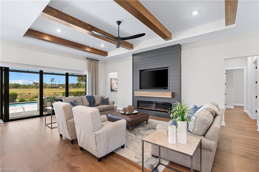 THIS STUNNING “STELLAR” HOME IN VERDANA VILLAGE IS AN ABSOLUTE SHOW STOPPER! ENGINEERED HARDWOOD FLOORS, SOARING CEILINGS WITH TRAYS & BEAMS, CUSTOM FIREPLACE WALL, ZERO CORNER SLIDERS, OUTDOOR KITCHEN, POOL/SPA, ALL WITH A PEACEFUL PRIVATE PRESERVE VIEW!! This Residence is situated on a SOUTHWEST REAR EXPOSURE homesite providing spectacular sunset vistas. Built by Pulte Homes in 2024, it offers 3 Bedrooms + Den, 3 Full Baths, 3 Car Garage with 4’ GARAGE EXTENSION, 2,493sf living area. This beautifully appointed home boasts a SPACIOUS COVERED LANAI equipped with a CUSTOM OUTDOOR KITCHEN, MOTORIZED AWNINGS AND SUNSCREENS. The screened pavered deck extends out 23 feet, providing extra space for entertaining. Enjoy the NATURAL GAS HEATED CUSTOM POOL, FLUSH SPA AND SUNSHELF accented by the PICTURE WINDOW SCREEN which enhances your WIDE-OPEN VIEW of the Preserve. Inside you’ll find beautifully designed spaces showcasing WOOD TRIM, upscale lighting and ceiling fans, MOTORIZED BLINDS in the main area, and DESIGNER ACCENTS which create warm and inviting spaces. ENGINEERED HARDWOOD FLOORING flows throughout the home with tile in the wet areas (NO CARPET ANYWHERE!). The Gourmet Kitchen boasts 2 FULL SIZE OVENS, GAS COOKTOP, White Perimeter Cabinetry with 42” Upper Cabinets, SOFT CLOSE doors/drawers, Admiral Blue Kitchen Island, QUARTZ counters, KITCHEN AID STAINLESS STEEL APPLIANCES, UNDERCABINET LIGHTING and BUILT IN SHELVING in the WALK-IN PANTRY. The Greatroom features an ELECTRIC FIREPLACE FEATURE SHIPLAP WALL complimented by RUSTIC WOOD BEAMS in the TRAY CEILING. ZERO CORNER SLIDERS open to the lanai creating a seamless INDOOR/OUTDOOR experience. The Primary Suite boasts a TRAY CEILING with BEAMS. The Primary Bathroom exudes a Luxurious feel with a Carrara Inspired design, QUARTZ Countertops, Dual sinks, HEAVY GLASS SHOWER ENCLOSURE with tile to the ceiling, private water closet and a LARGE WALK IN CLOSET with BUILT IN ORGANIZERS. The two guest bedrooms provide a tranquil place for your guest to relax joined by two guest bathrooms (One Guest Bath is EN-SUITE). The Den with Glass Doors provides a quiet and private office space or flex space. The Laundry is complete with a LG washer/dryer, Custom Cabinetry and sink. Garage is equipped with epoxy floor, TANKLESS WATER HEATER, Cabinetry, MINI SPLIT AC, and insulated garage doors. Other features include: GENERAC WHOLE HOME GENERATOR, Security System, IMPACT WINDOWS/DOORS, Drop Zone, SCREENED FRONT ENTRY, HVAC PureAir System, KINETICO WATER FILTRATION. THIS PROPERTY IS HIGH AND DRY AND LOCATED IN FLOOD ZONE X... NO FLOOD INSURANCE REQUIRED! Amenities include Indoor/Outdoor Pickleball & Tennis, Indoor basketball, Bocce, Clubhouse, Dog Park, Resort-style Pool & Spa, Fitness center, Movement Studio, Playground, Restaurant, Craft Beer lounge, Cafe and Indoor/Outdoor bar. Satellite amenity includes Social Room, Pool/lap lanes, Fitness Center, Sports Field. Publix Plaza located just outside community gates!