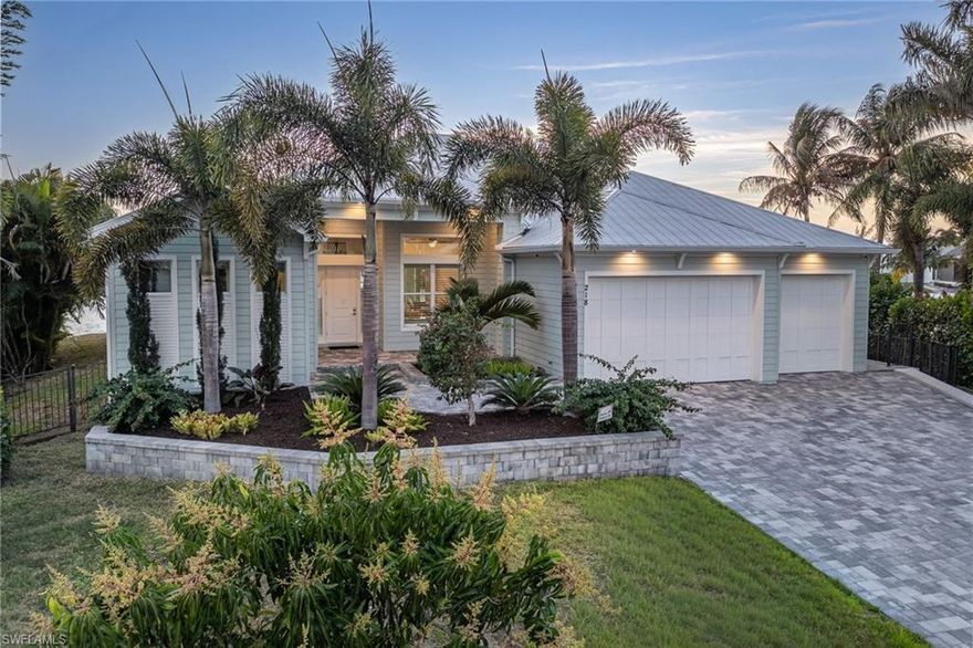 Located at 218 Bayshore Dr, this custom-built luxury residence offers the perfect combination of modern design, boating convenience, and resort-style outdoor living. This custom masterpiece is situated on an oversized “pie” shaped lot with 158-liner feet of waterfrontage, and a breath taking southwest rear exposure view encapsulating both the Caloosahatchee River and the 200FT+ wide Bimini canal. The private outdoor living environment is truly resort-inspired, featuring a negative-edge heated pool and spa, expansive travertine deck, summer kitchen, and multiple covered lounge areas ideal for entertaining. Boating enthusiasts will appreciate the new composite dock with a 16,000-pound boat lift, and immediate access to open water. Stepping inside, the open-concept great room connects effortlessly to a chef’s kitchen with premium appliances, custom cabinetry, and an oversized island designed for gatherings. The owner’s suite offers luxury at every turn with high-end finishes, a private outdoor shower, walk-in closet, and private pool access. The two guest bedrooms are thoughtfully positioned for maximum privacy, each featuring its own ensuite bathroom, providing comfort and convenience. This residence comes equipped with a 590-gallon gas tank, whole-home generator, metal roof, impact windows and doors, 3-car garage, lush tropical landscaping, and privacy fencing. This is a rare opportunity to own a standout Gulf-access residence at the southwest corner of the prestigious Bayshore Dr.