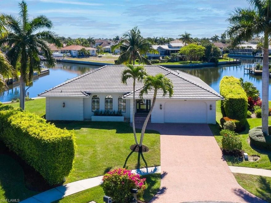 HIGH DEMAND - WIDE WATER - RENOVATED - TIP LOT HOME - RARE LOCATION FIND!  WALKING DISTANCE TO RESIDENTS BEACH!!!  Tropical paradise home with southeastern exposure.  Newly renovated with “state of the art” kitchen and bathrooms. Featuring high vaulted ceilings, sliding doors that collapse to bring the “outdoors in”.  EVERY room has a water view with palm trees.  Custom built kitchen cabinetry, 6 burner Wolf GAS stove, Viking refrigerator, dishwasher, and microwave.  Wine cooler, oversized granite island for entertaining. Separate living room and family room. New modern office with custom floating quartz counters and large cabinetry that converts to a Murphy queen bedroom. Updated modern trim and doors throughout. Large pool (31' x 15') and travertine patio area with picture window screens. New roof.  Freshly painted interior and exterior. Trees are accentuated with professional up lighting.  Hurricane protection shutters.
One of the better floor plan designs by FCI builders.