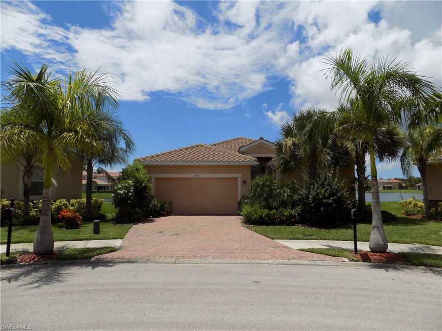 This is not your average home in Olympia Pointe!  The seller has taken every opportunity to enhance this property.  The house has been upgraded by replacing all the windows with hurricane impact windows.  The kitchen has been upgraded to include additional cabinet space, custom pantry shelving and upgraded appliances and faucets/fixtures.  The kitchen has a light tube to give additional light.  The master bath has a frame less shower door and custom cabinetry for additional drawer space.  The garage door has been insulated and reinforced for additional hurricane support.  This home is tiled in all areas except the 3 bedrooms.  The den area is opened and tiled.  The extended lanai give a great view of the large lake and the water feature.   Additional landscaping with a variety of fruit trees makes this a true Florida home!